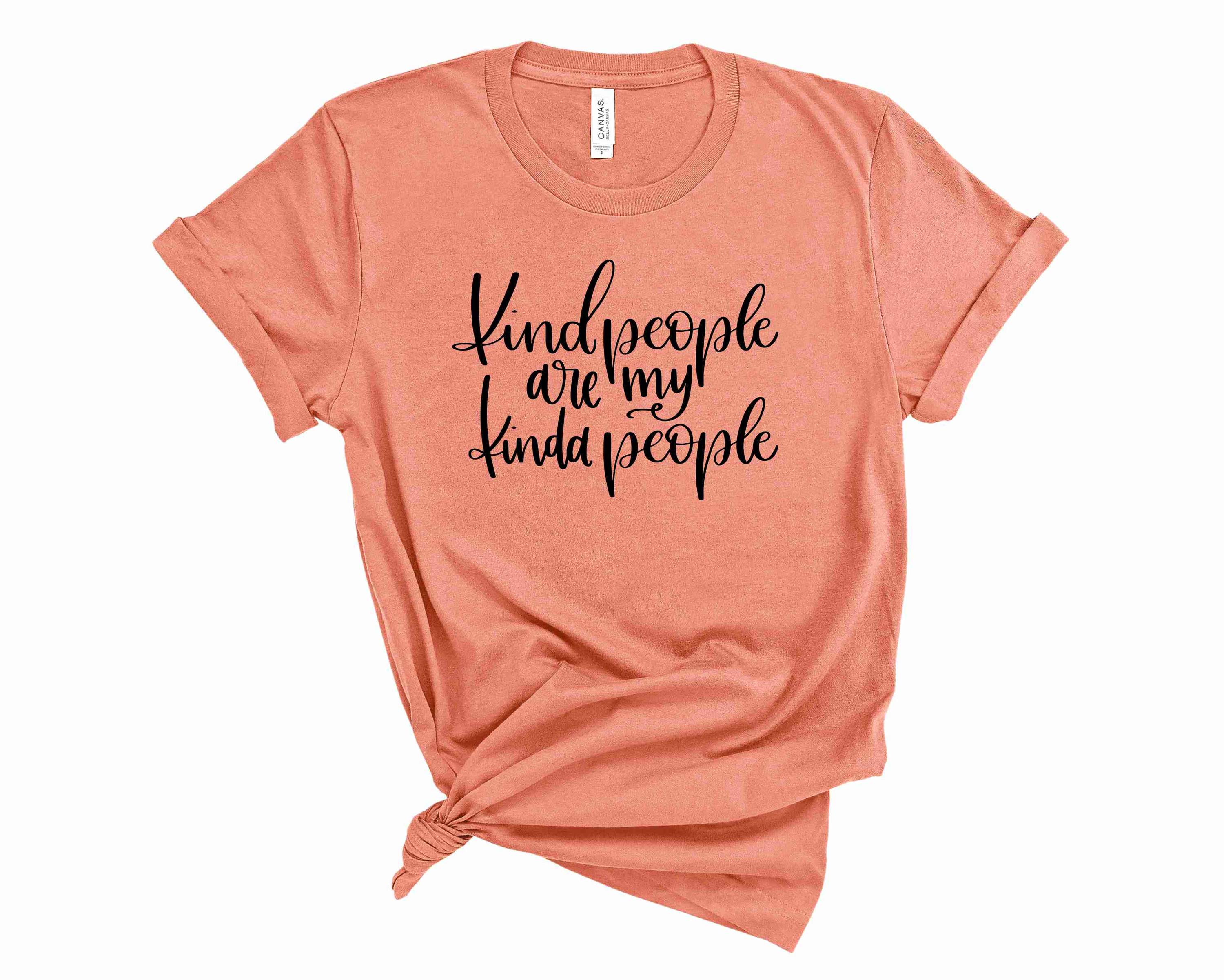 A unisex graphic tee featuring the phrase 'Kind People Are My Kinda People' in bold letters, showcasing a vibrant and positive design.