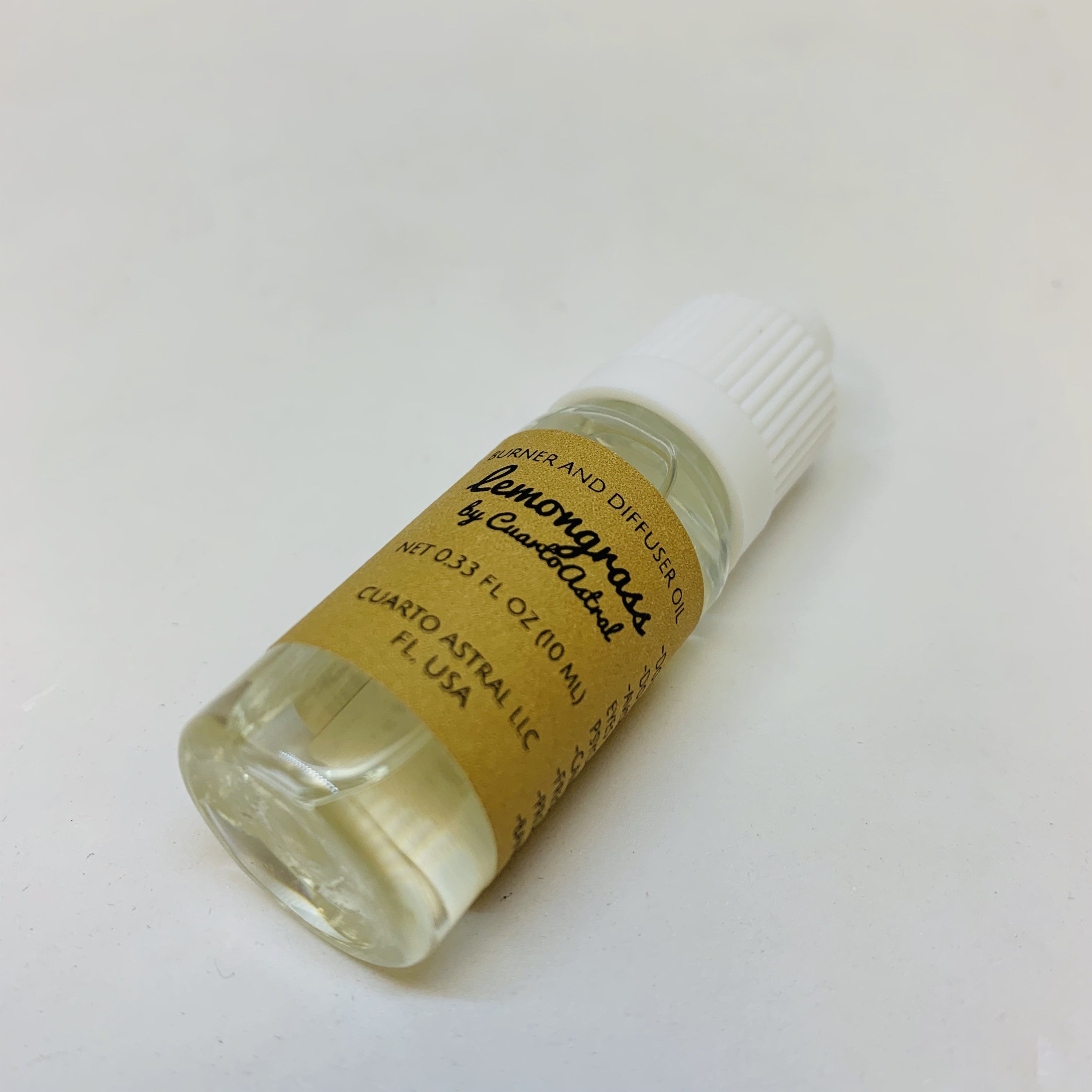 A 10ml bottle of CuartoAstral Lemongrass essential oil, showcasing its vibrant green label and sleek design, perfect for aromatherapy.