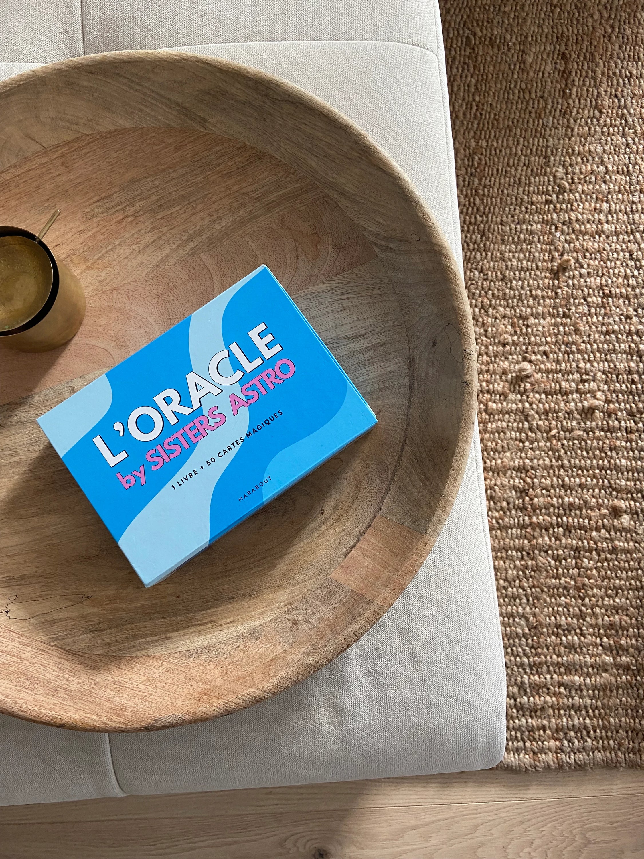 L'Oracle by Sisters Astro featuring 50 illustrated cards, an 80-page guidebook, and a stylish carrying pouch, all designed for spiritual guidance.