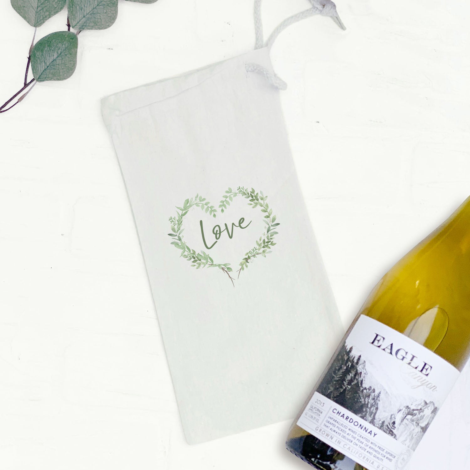 Love Greenery Heart Wreath canvas wine bag featuring a heart wreath design, made from durable cotton canvas with a drawstring closure.