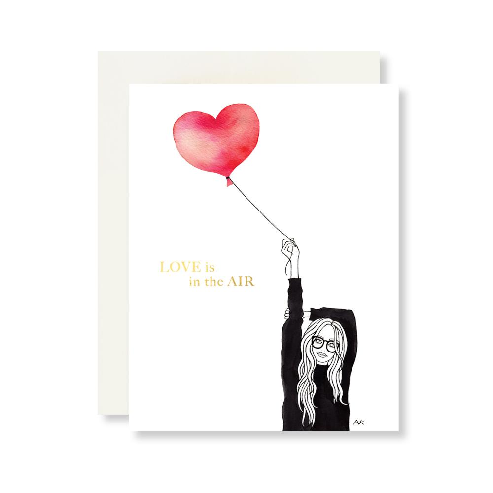 A beautifully illustrated card featuring a heart balloon design, printed on high-quality paper with gold foil stamping, accompanied by a quartz metallic envelope.