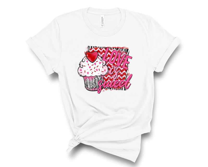 A unisex t-shirt featuring a colorful cupcake graphic with the text 'Love is Sweet'.