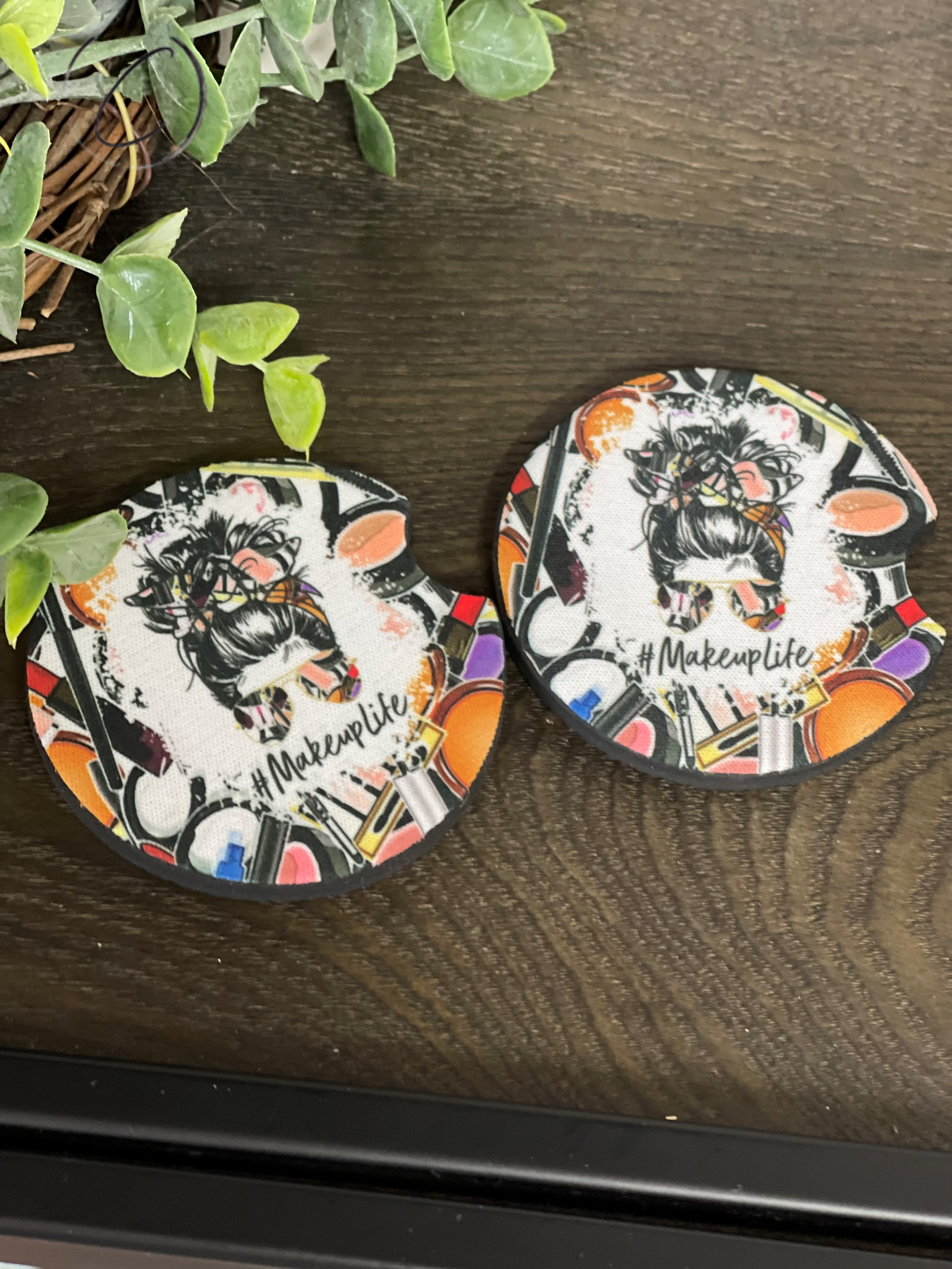 A stylish #MakeupLife car coaster set made of durable neoprene, featuring vibrant designs, perfect for cup holders.