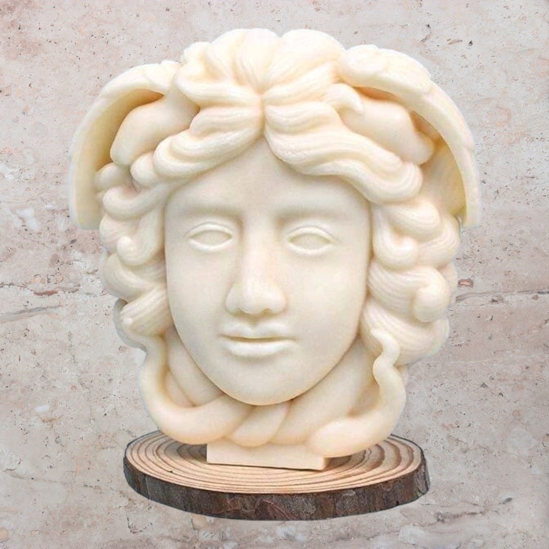 A beautifully crafted Medusa Sculptural Candle featuring intricate details and a warm flickering flame, perfect for home decor.