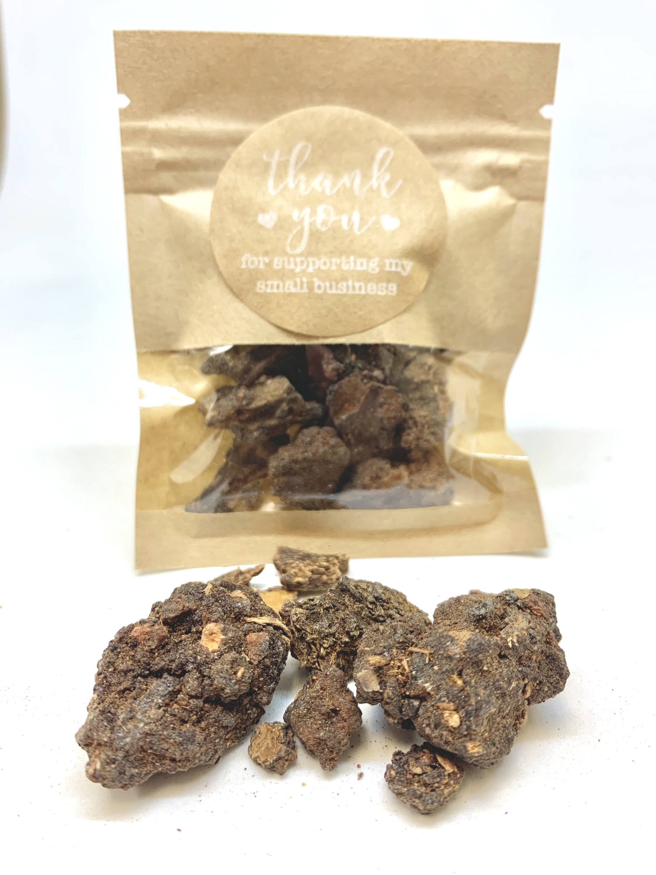 A small container of Myrrh resin, showcasing its natural earthy color and texture, ideal for burning as incense.