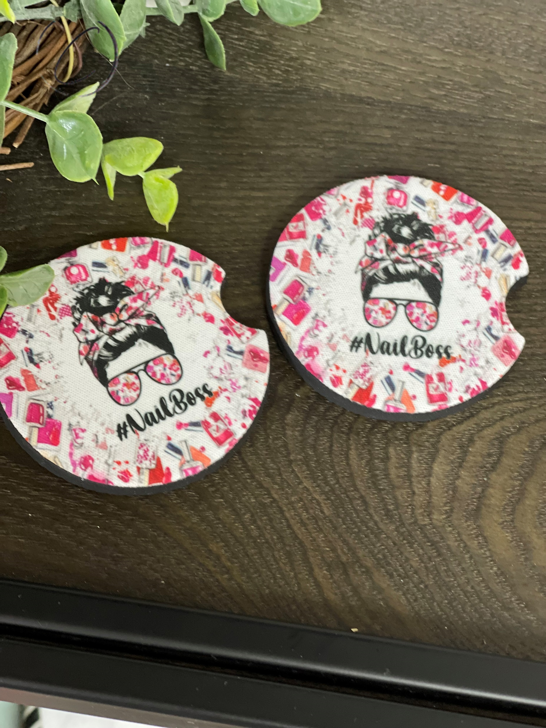 A stylish #NailBoss car coaster set made of durable neoprene, featuring a vibrant design, perfect for enhancing car interiors.