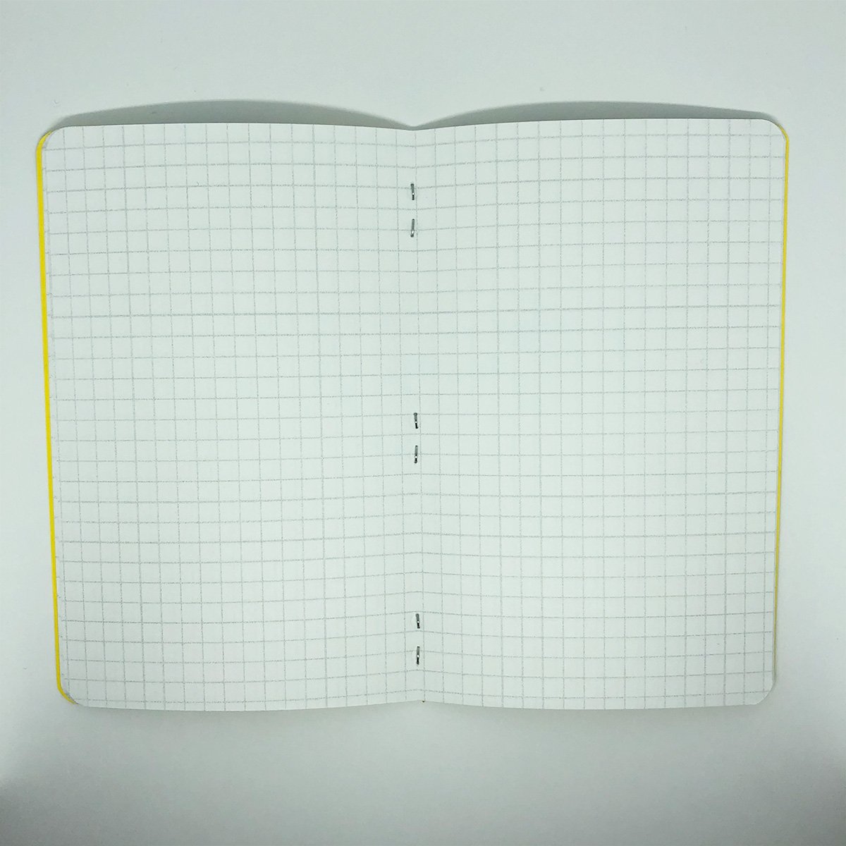 Two Neon Marble grid memo books featuring unique marble patterns on colorful covers, showcasing their compact size and high-quality design.