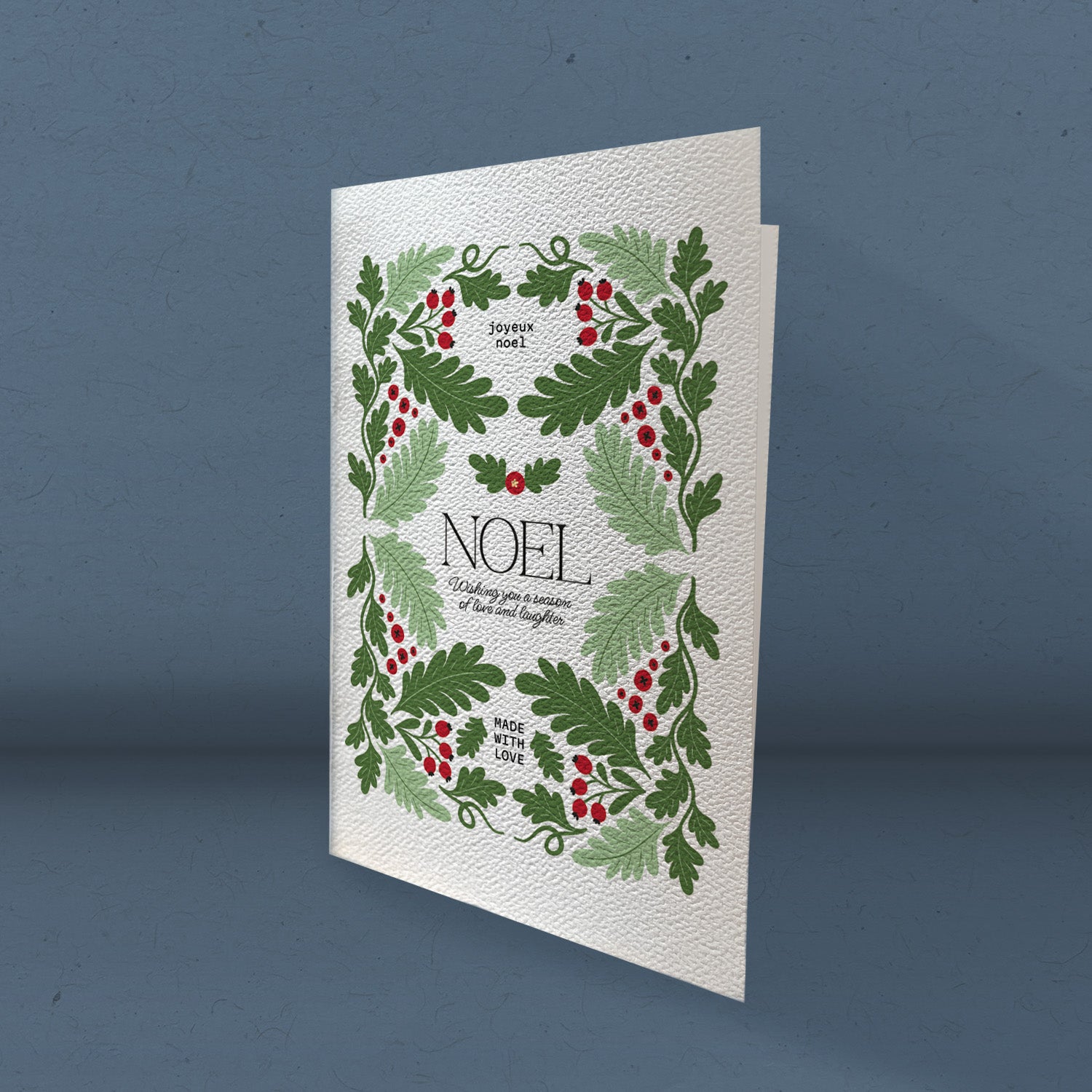 Noel greeting card featuring elegant design on high-quality cardstock with a felt finish, displayed with an envelope.