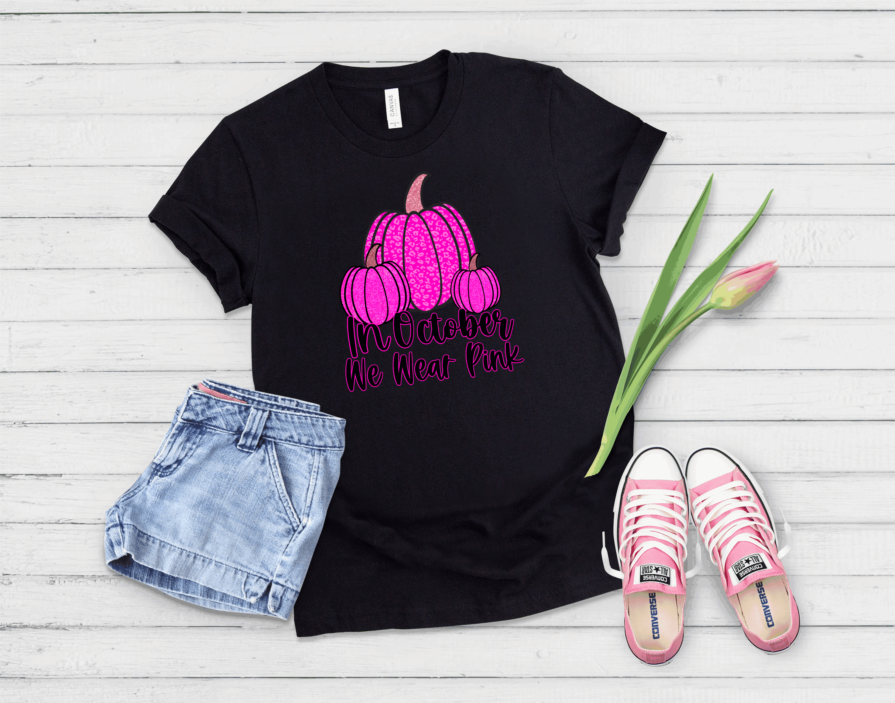 A stylish unisex graphic tee featuring vibrant pink pumpkins, perfect for October celebrations.