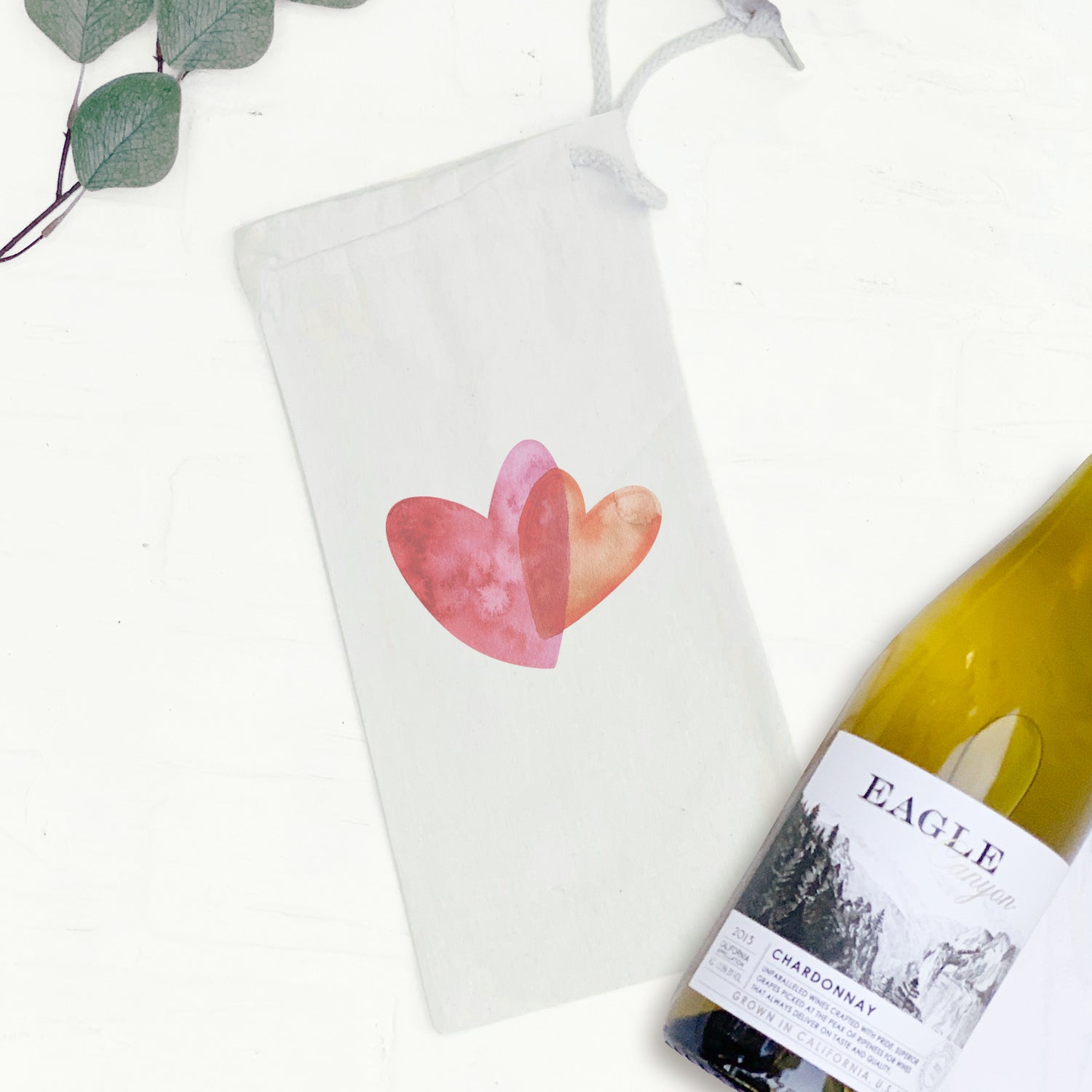 Orange and pink canvas wine bag featuring double heart design, perfect for gifting wine bottles.