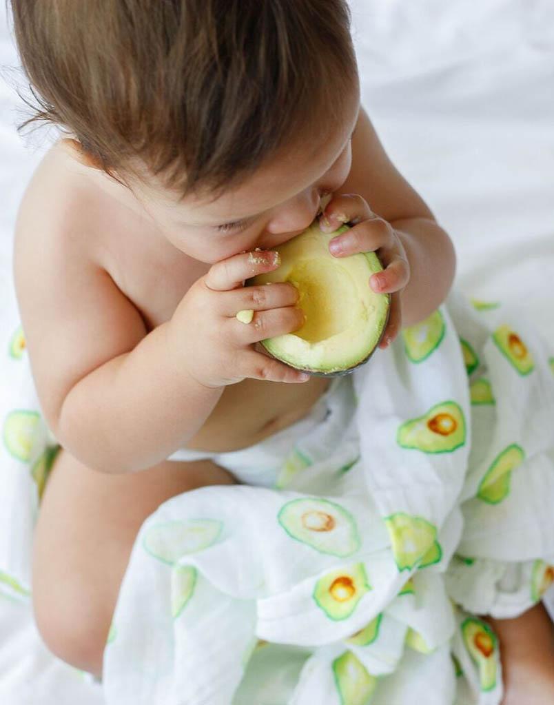 Luxuriously soft organic cotton swaddle in avocado color, perfect for wrapping babies comfortably.