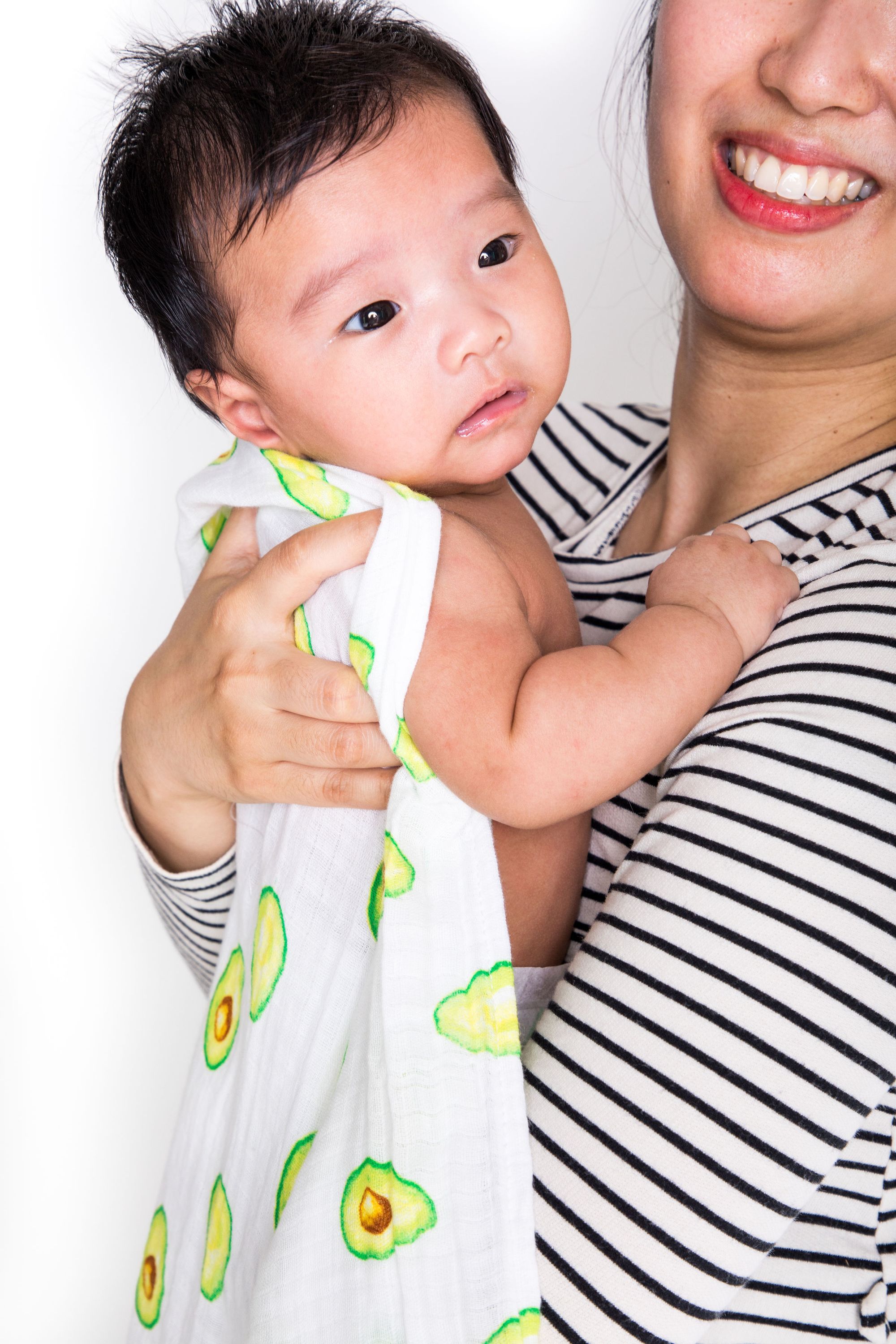 Luxuriously soft organic cotton swaddle in avocado color, perfect for wrapping babies comfortably.