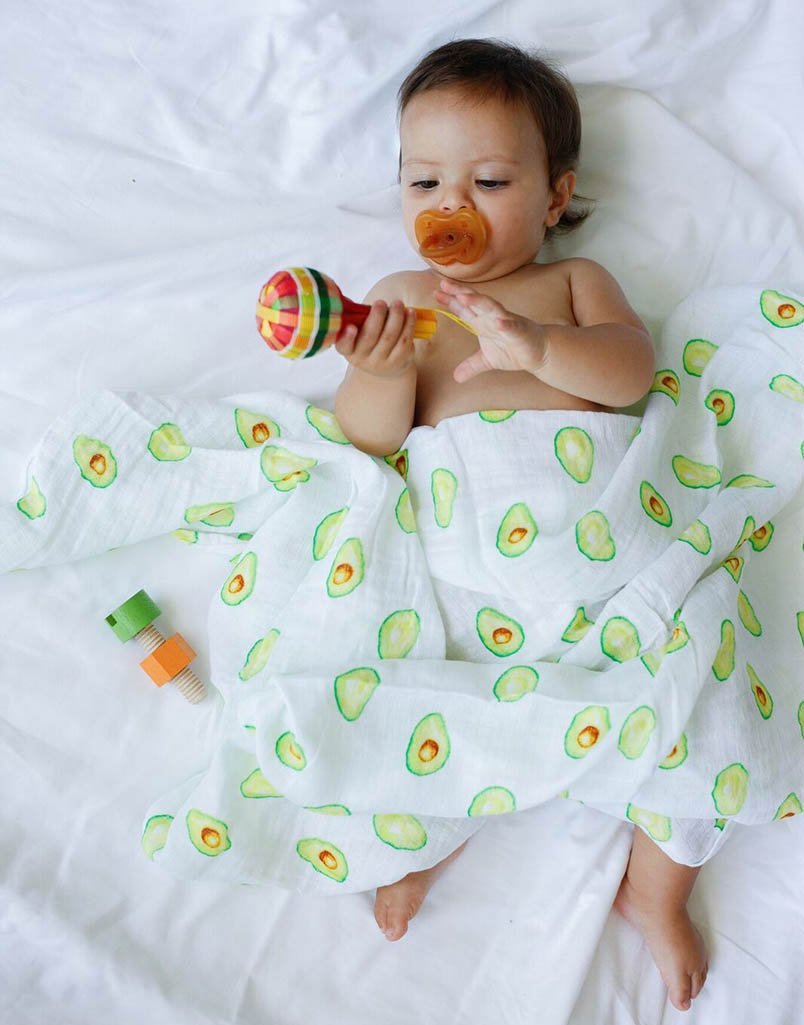 Luxuriously soft organic cotton swaddle in avocado color, perfect for wrapping babies comfortably.