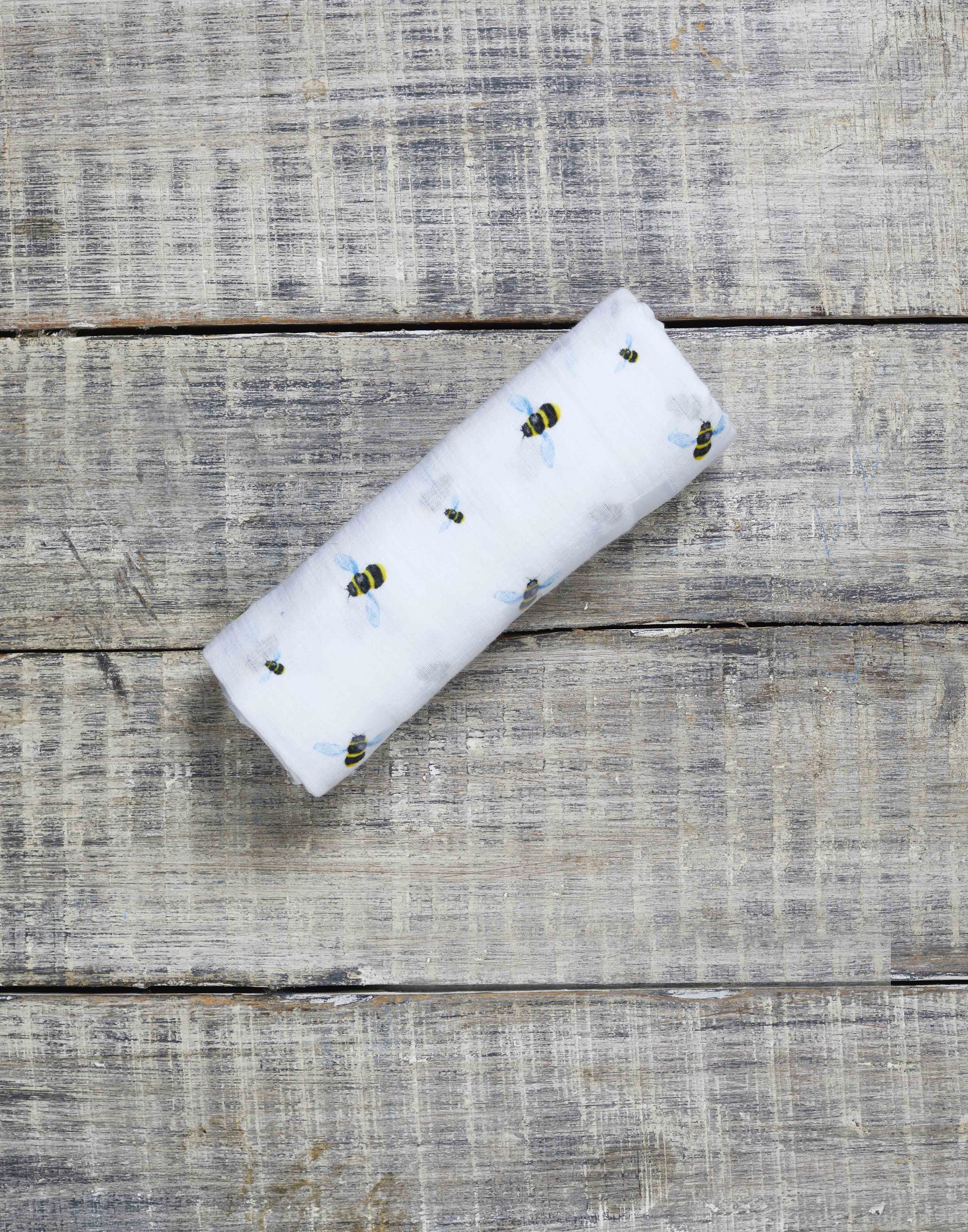 Organic Swaddle - Bee made from soft GOTS certified cotton, featuring a bee pattern, perfect for swaddling babies.