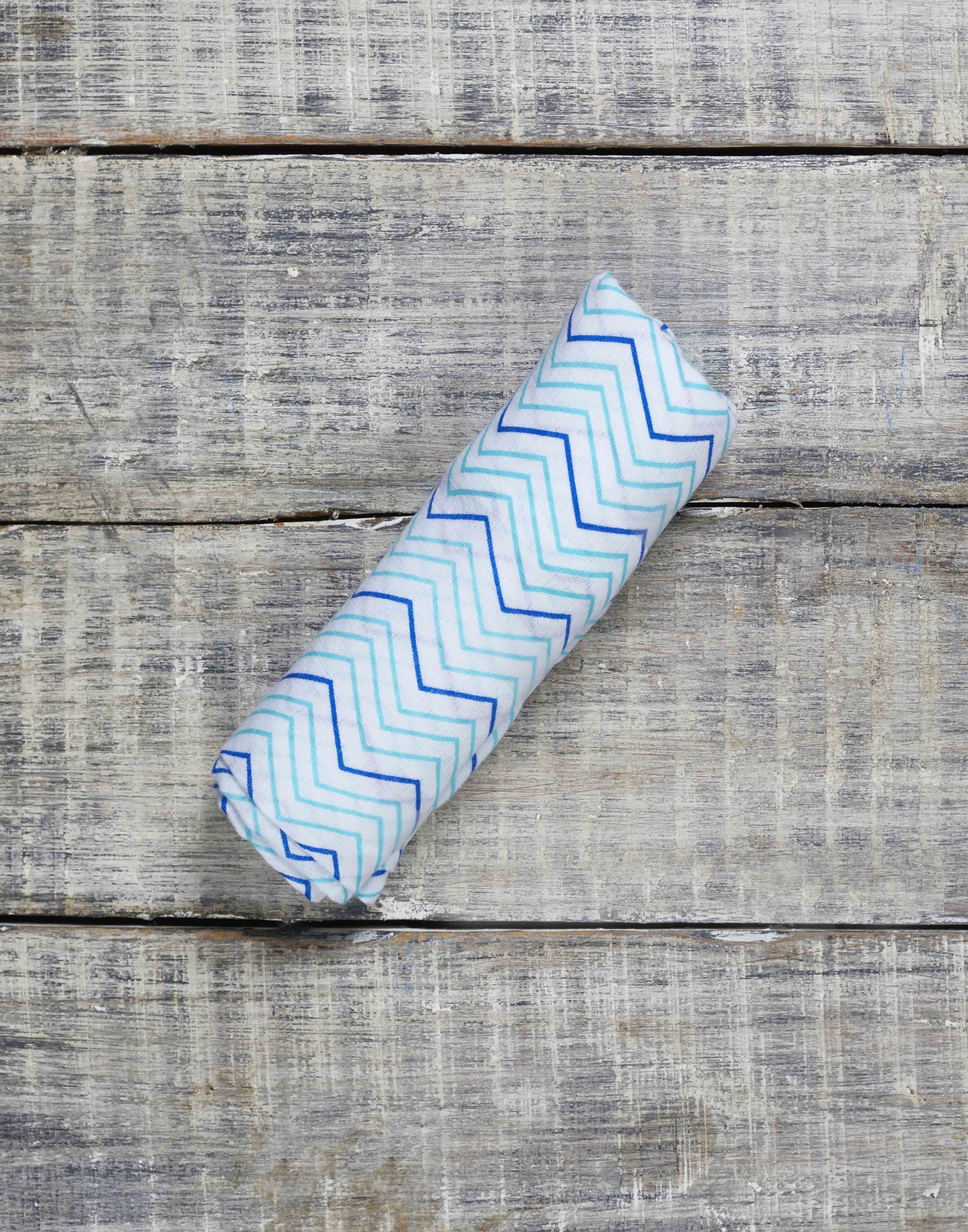 Luxuriously soft organic cotton swaddle in Chevron design, perfect for snuggling and versatile use.