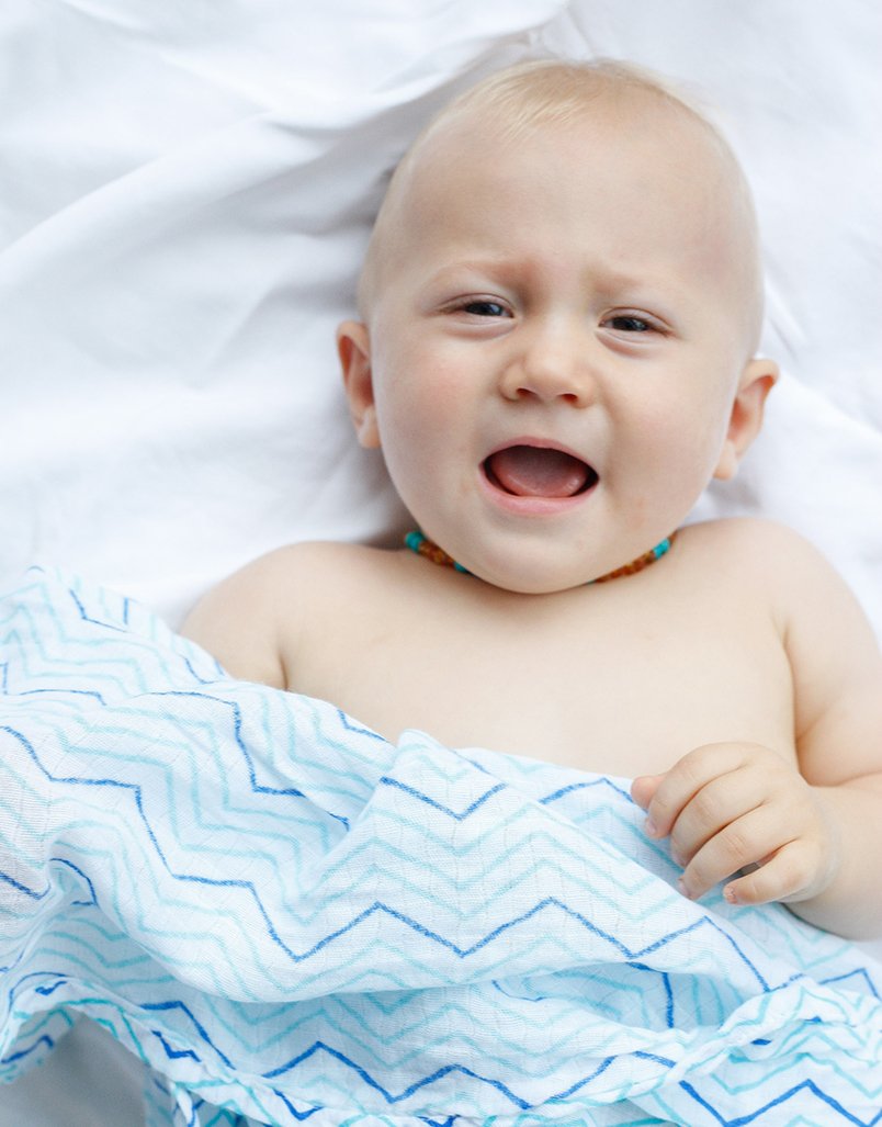 Luxuriously soft organic cotton swaddle in Chevron design, perfect for snuggling and versatile use.