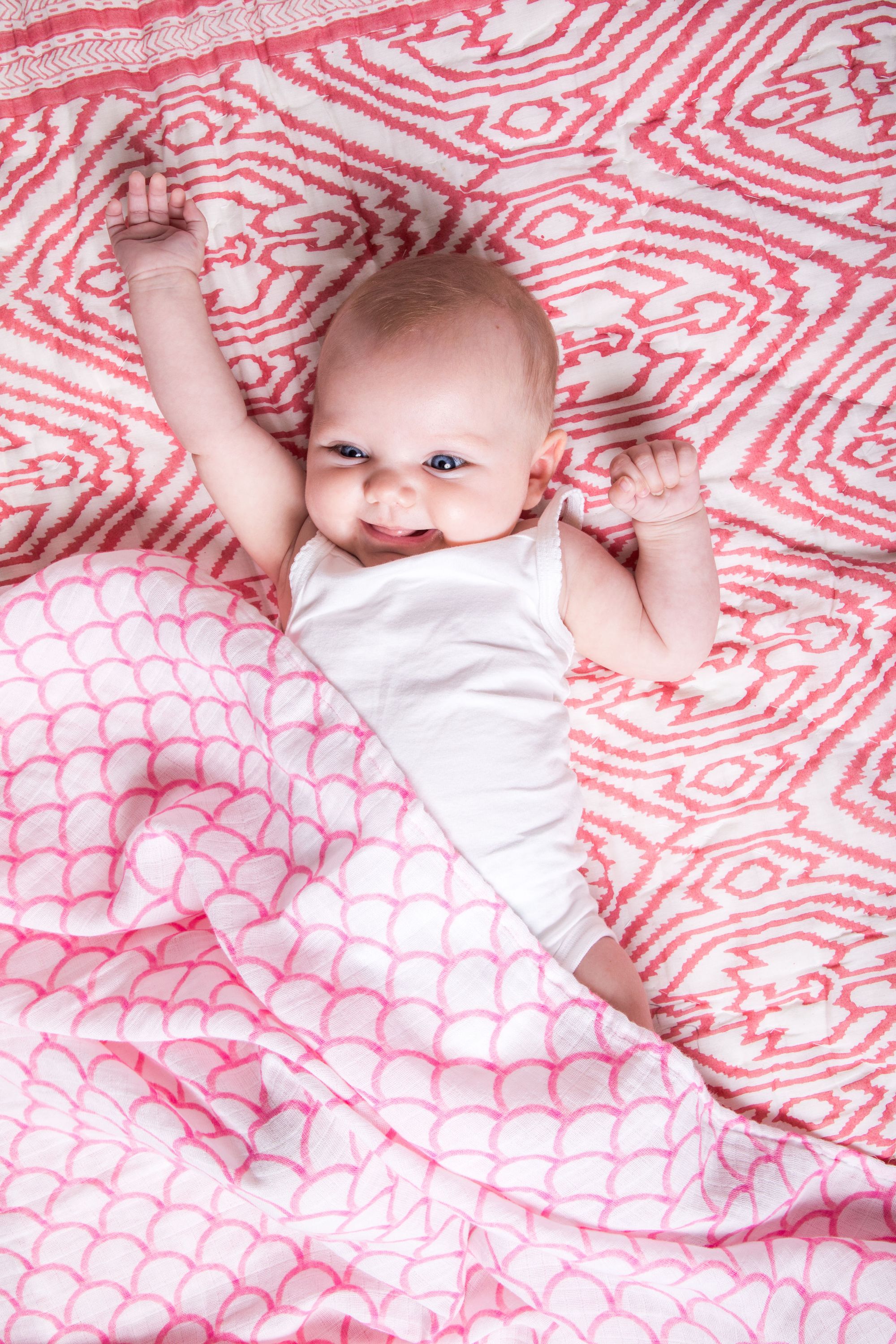 Organic Swaddle in Pink Rainbow, made from soft GOTS certified cotton, featuring a vibrant rainbow design.