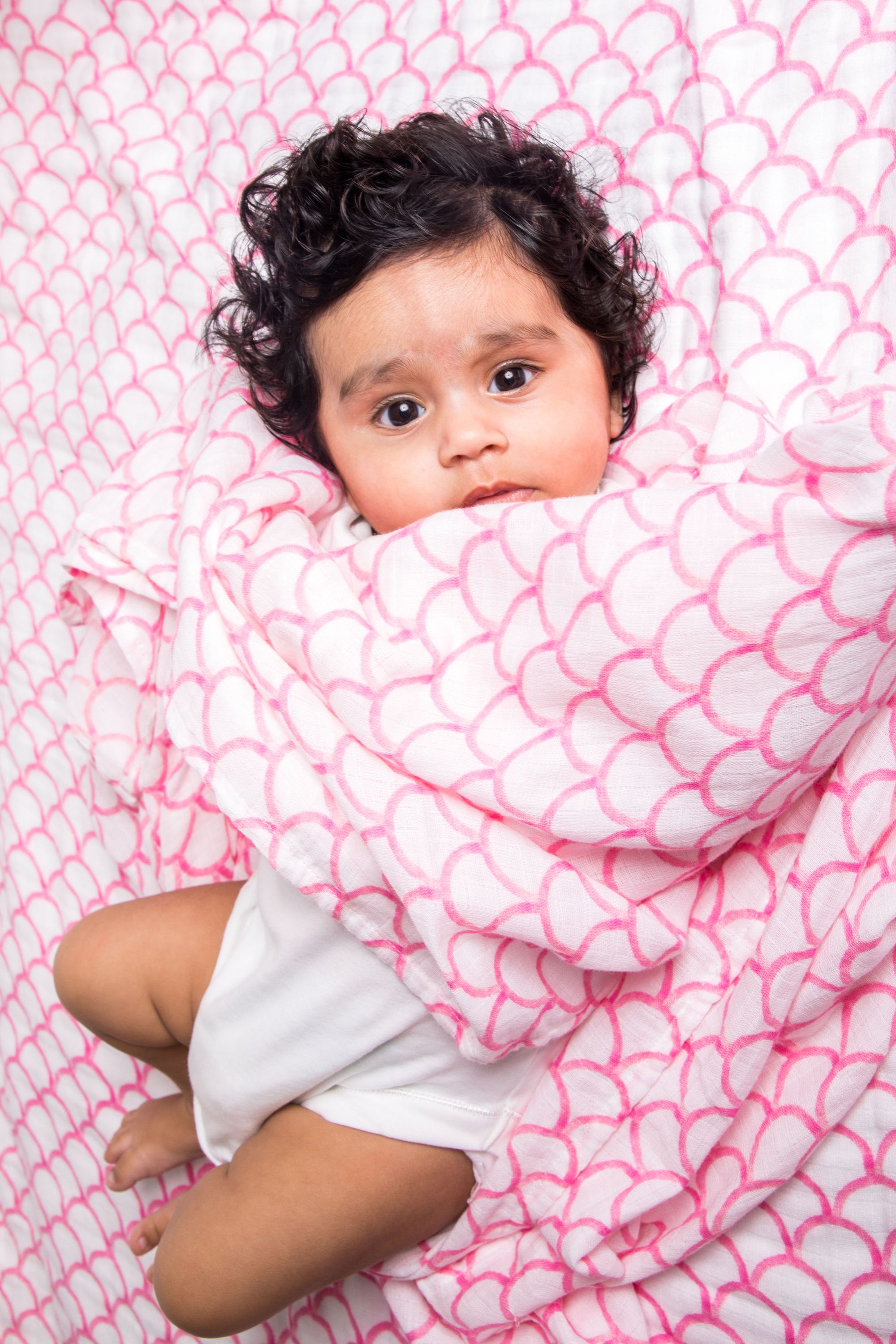 Organic Swaddle in Pink Rainbow, made from soft GOTS certified cotton, featuring a vibrant rainbow design.