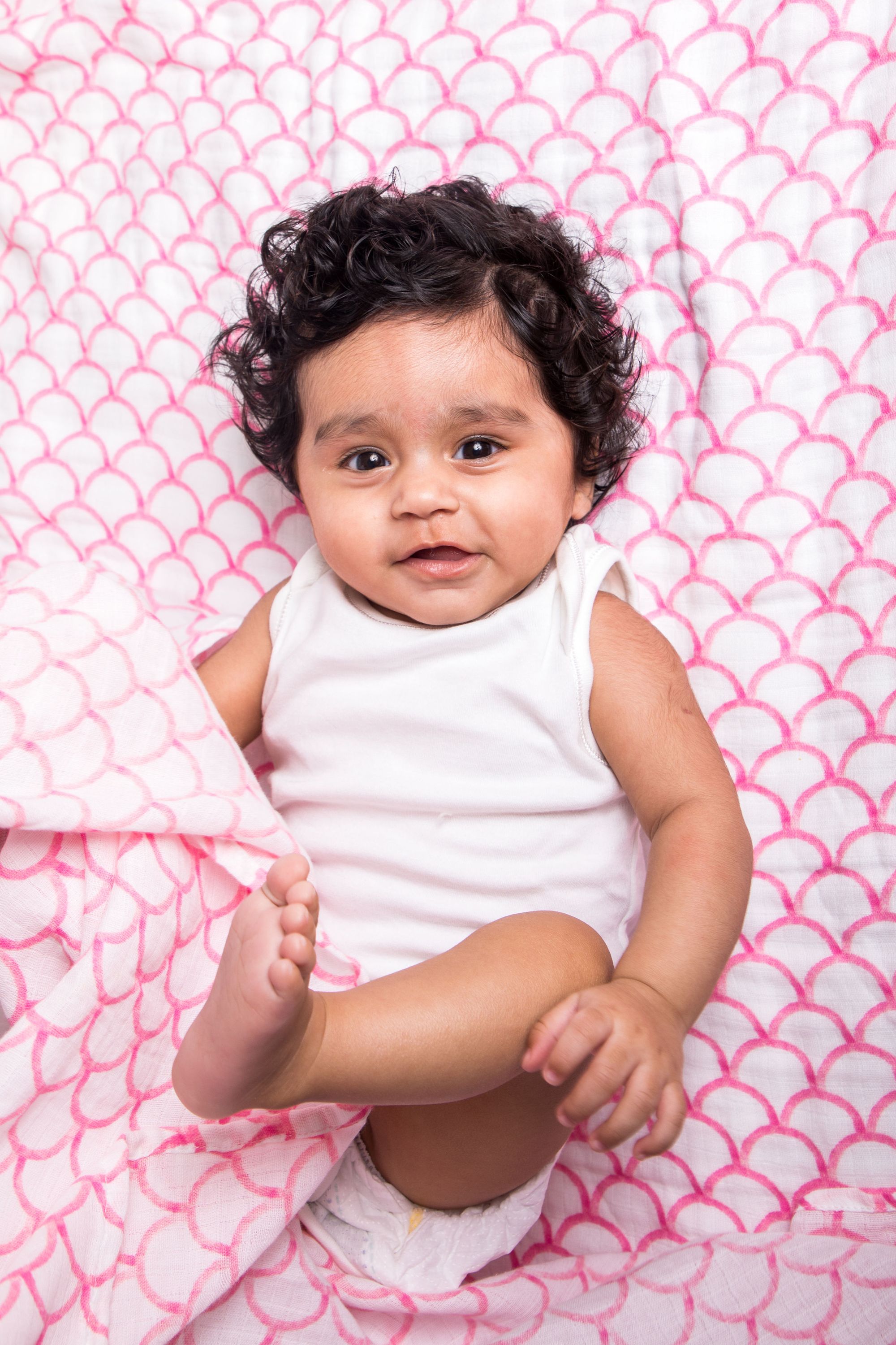 Organic Swaddle in Pink Rainbow, made from soft GOTS certified cotton, featuring a vibrant rainbow design.