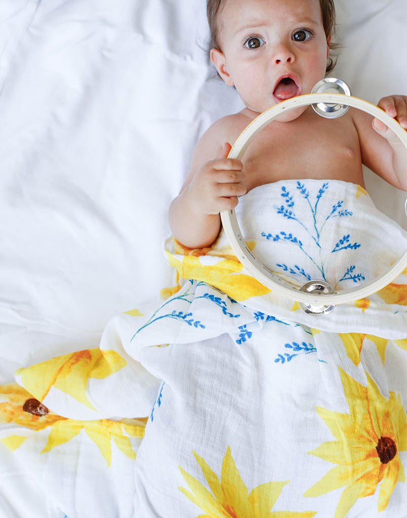 Organic Swaddle in Sunflower design, made from soft GOTS certified cotton, perfect for snuggling and versatile use.