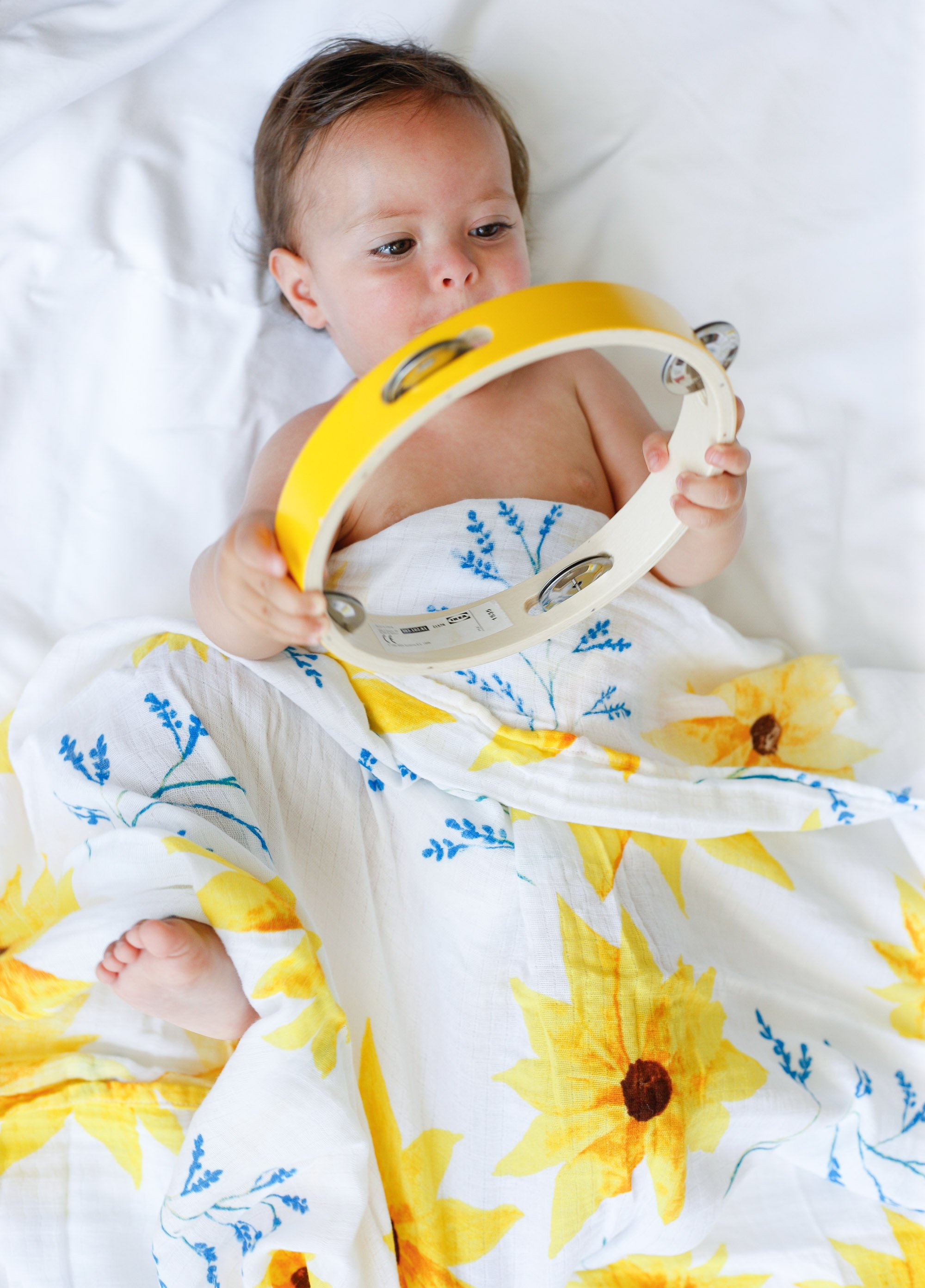 Organic Swaddle in Sunflower design, made from soft GOTS certified cotton, perfect for snuggling and versatile use.