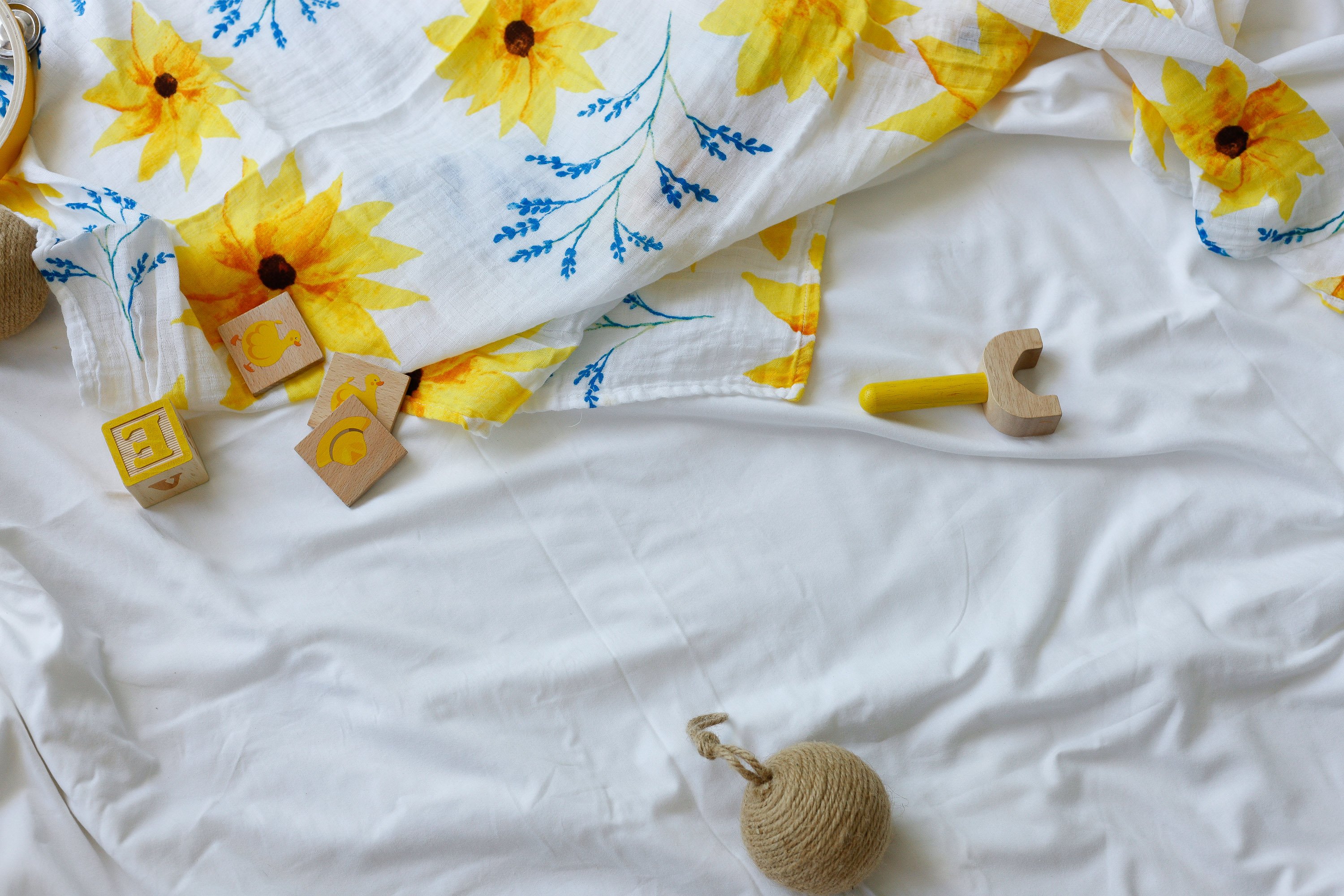 Organic Swaddle in Sunflower design, made from soft GOTS certified cotton, perfect for snuggling and versatile use.