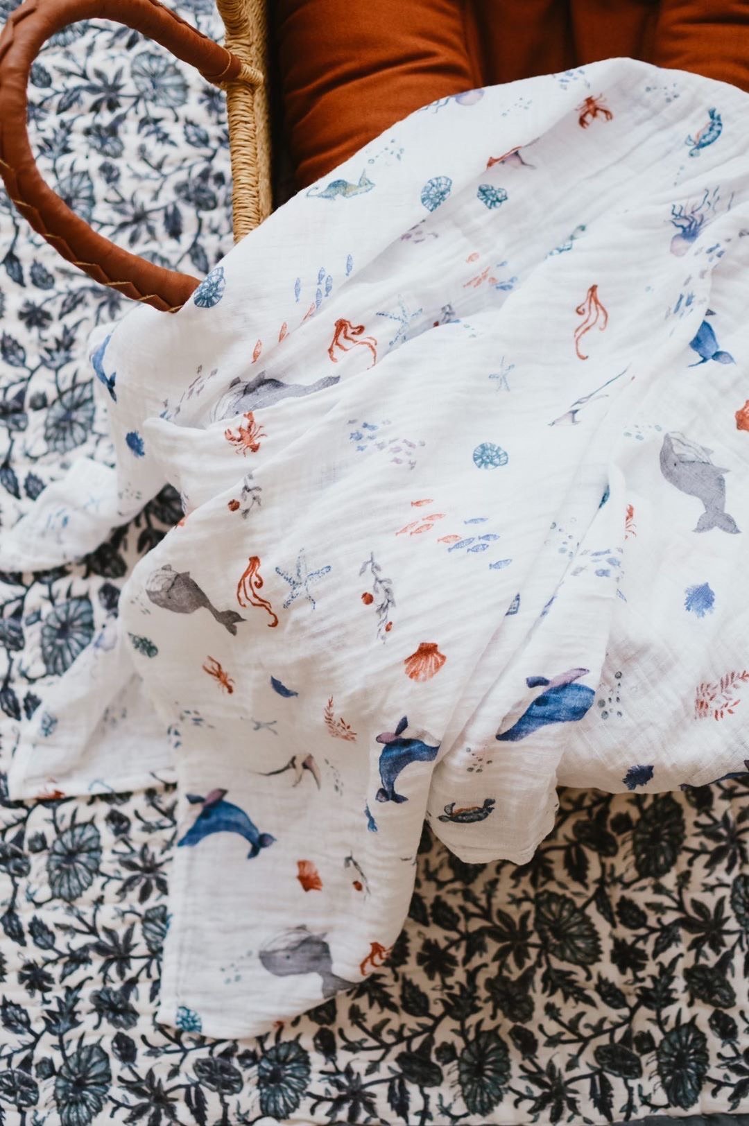 Organic Swaddle featuring an Under the Sea design with sea creatures, made from soft GOTS certified organic cotton.