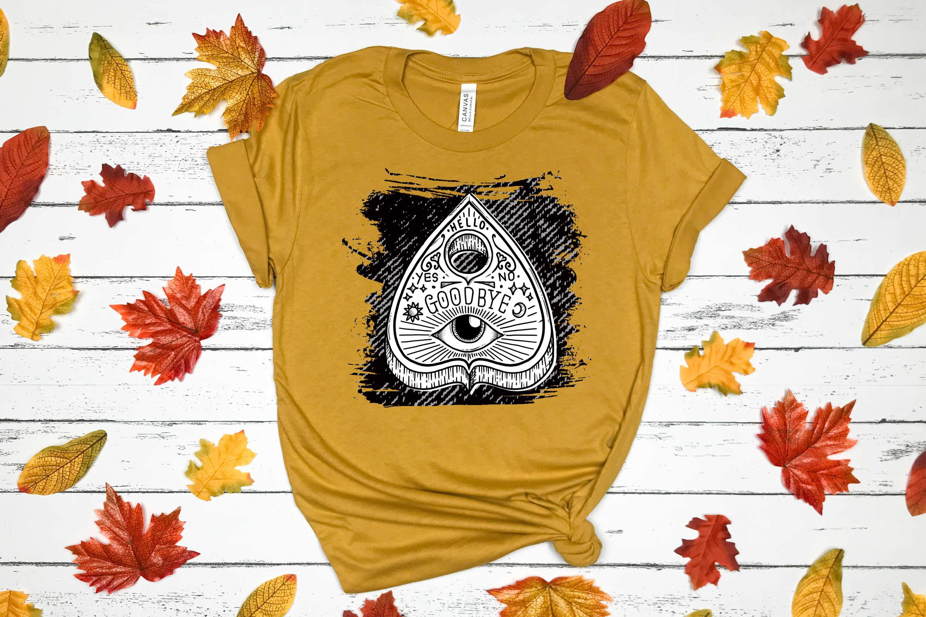 Ouija Planchette Graphic Tee featuring a mystical design on a Bella Canvas unisex t-shirt.