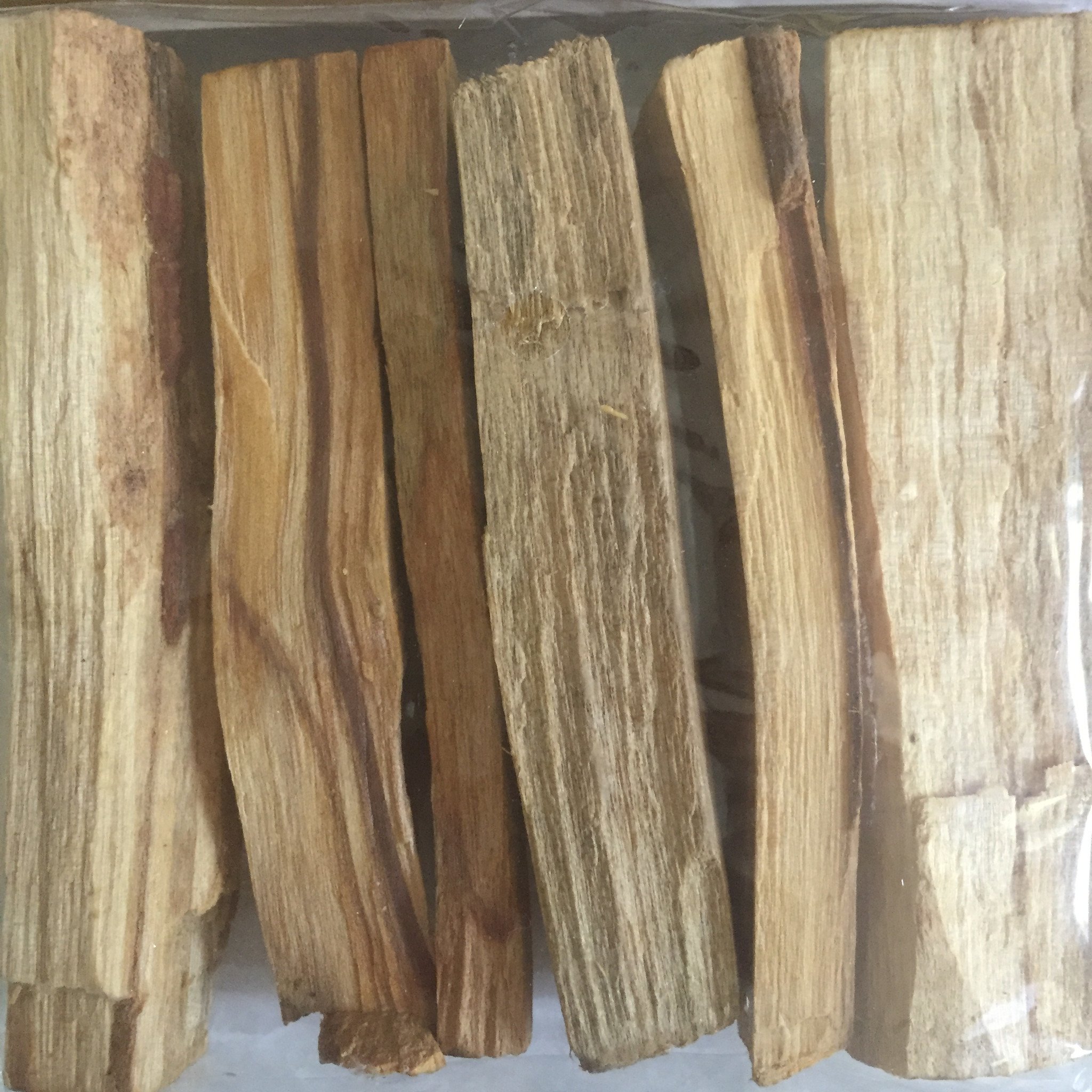 A piece of Palo Santo wood measuring approximately 4 inches by 1 inch, showcasing its natural texture and color, ideal for spiritual cleansing and protection.