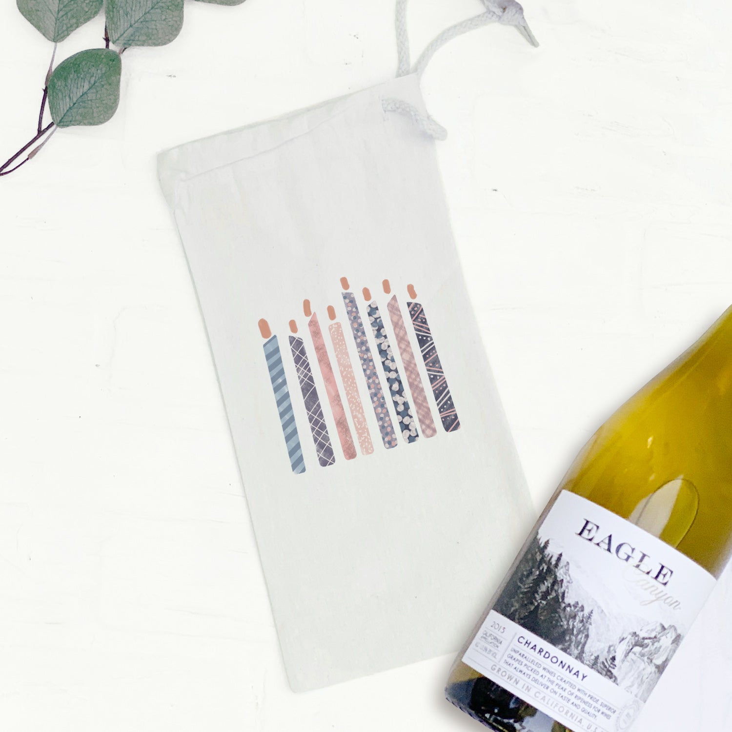 A stylish canvas wine bag with a drawstring closure, designed to hold a 750mL wine bottle, perfect for parties and gifting.