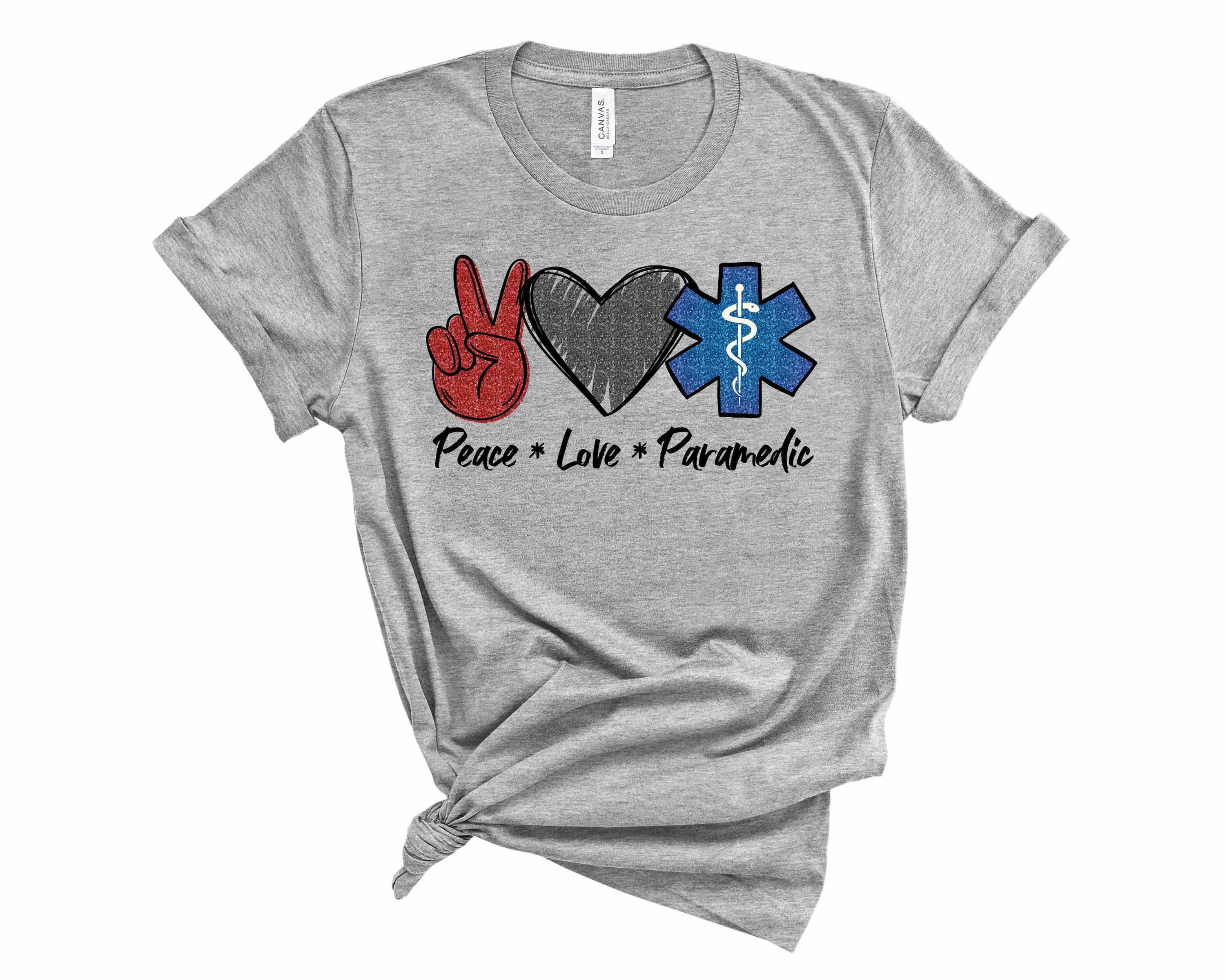 A unisex graphic tee featuring the words 'Peace Love Paramedic' in a stylish design, perfect for paramedics and their supporters.