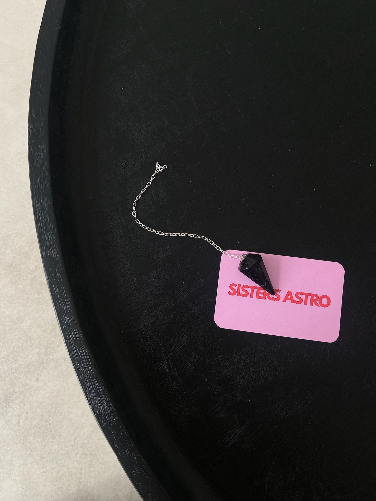 PENDULE TOURMALINE pendulum with a crystal design, showcasing its protective properties and intuitive guidance features.