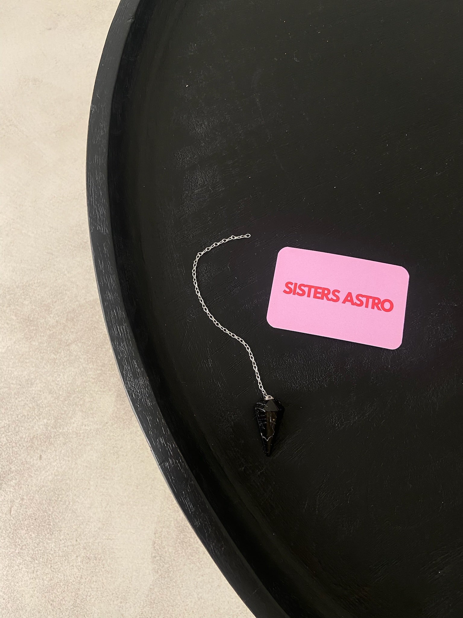 PENDULE TOURMALINE pendulum with a crystal design, showcasing its protective properties and intuitive guidance features.