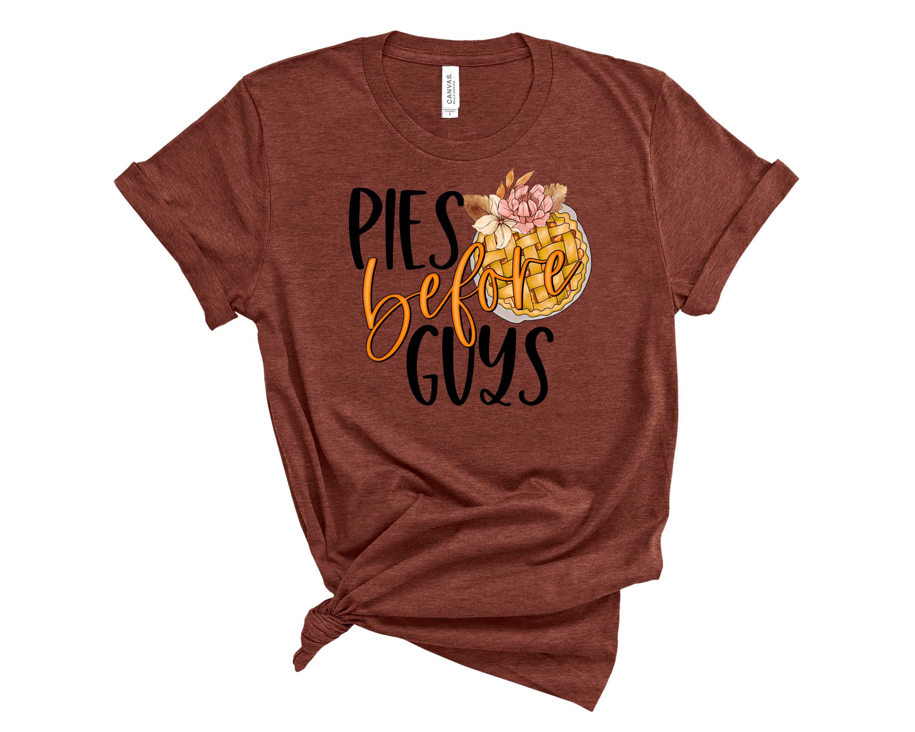 A unisex graphic tee featuring the phrase 'Pies Before Guys' in bold lettering, showcasing a fun and playful design.
