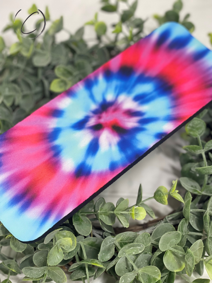 Pink and blue tie dye slap wrap can cooler designed for 12oz cans and bottles, made of durable neoprene material.