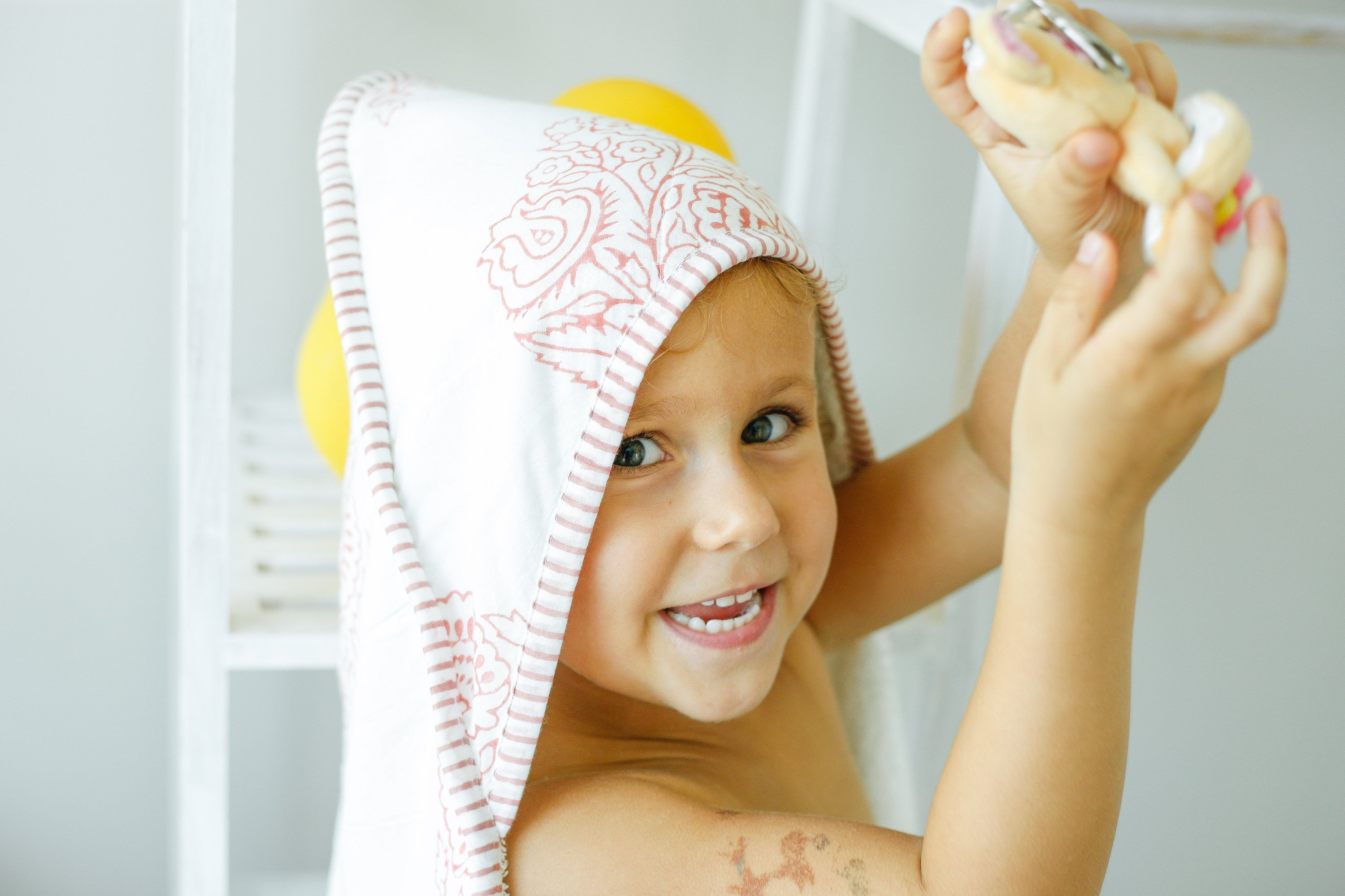 A beautifully crafted PINK CITY TOWEL featuring hand-printed floral motifs in rose hues, showcasing its unique design and soft cotton texture.
