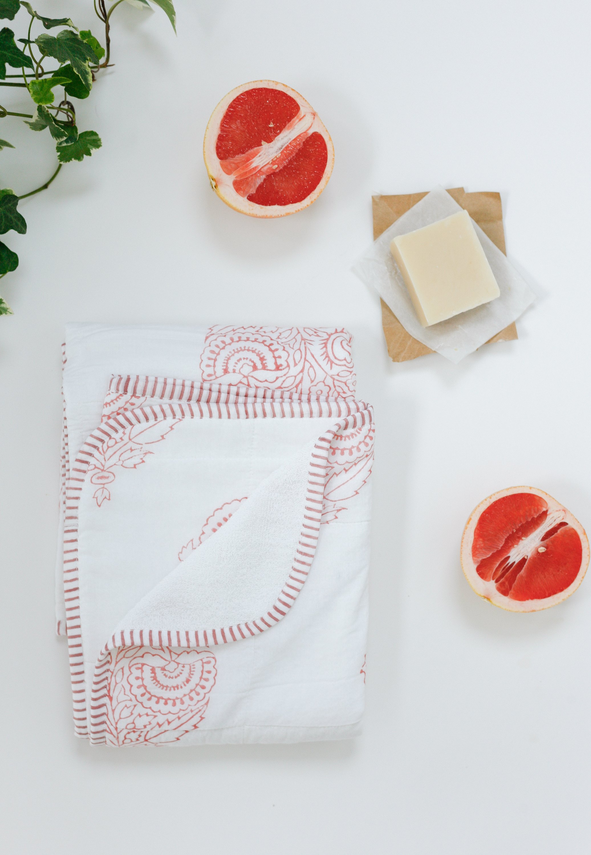A beautifully crafted PINK CITY TOWEL featuring hand-printed floral motifs in rose hues, showcasing its unique design and soft cotton texture.