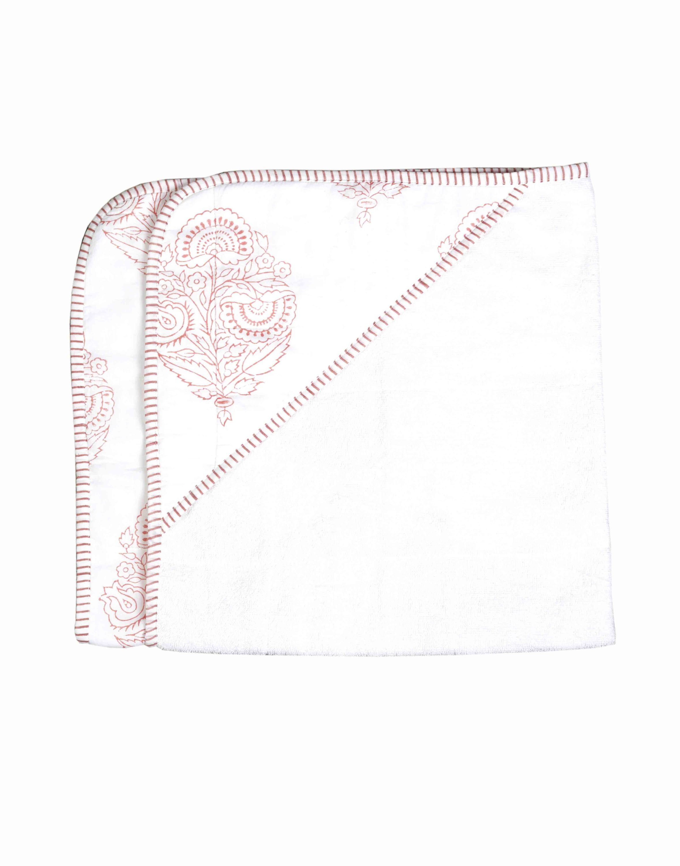 A beautifully crafted PINK CITY TOWEL featuring hand-printed floral motifs in rose hues, showcasing its unique design and soft cotton texture.