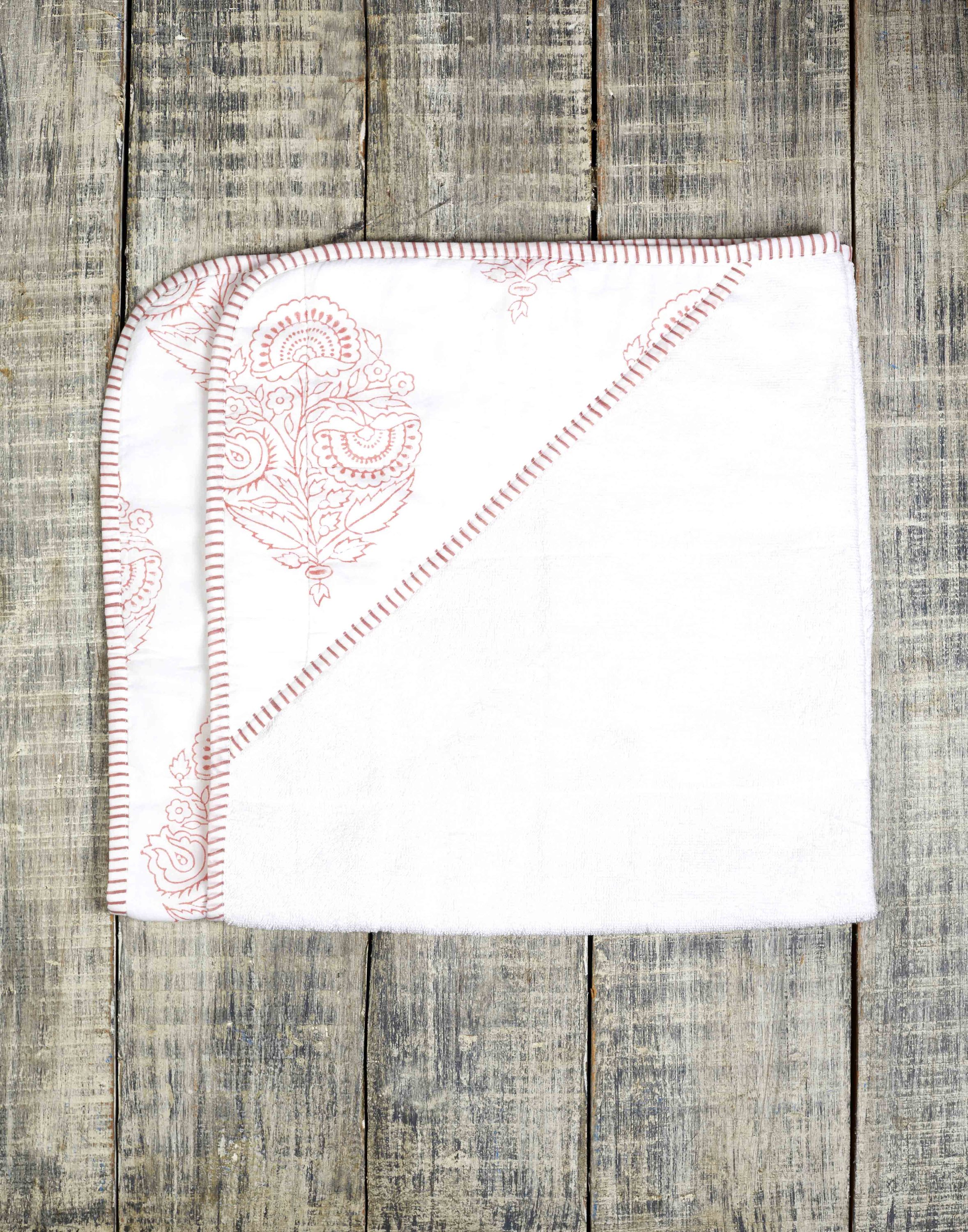 A beautifully crafted PINK CITY TOWEL featuring hand-printed floral motifs in rose hues, showcasing its unique design and soft cotton texture.