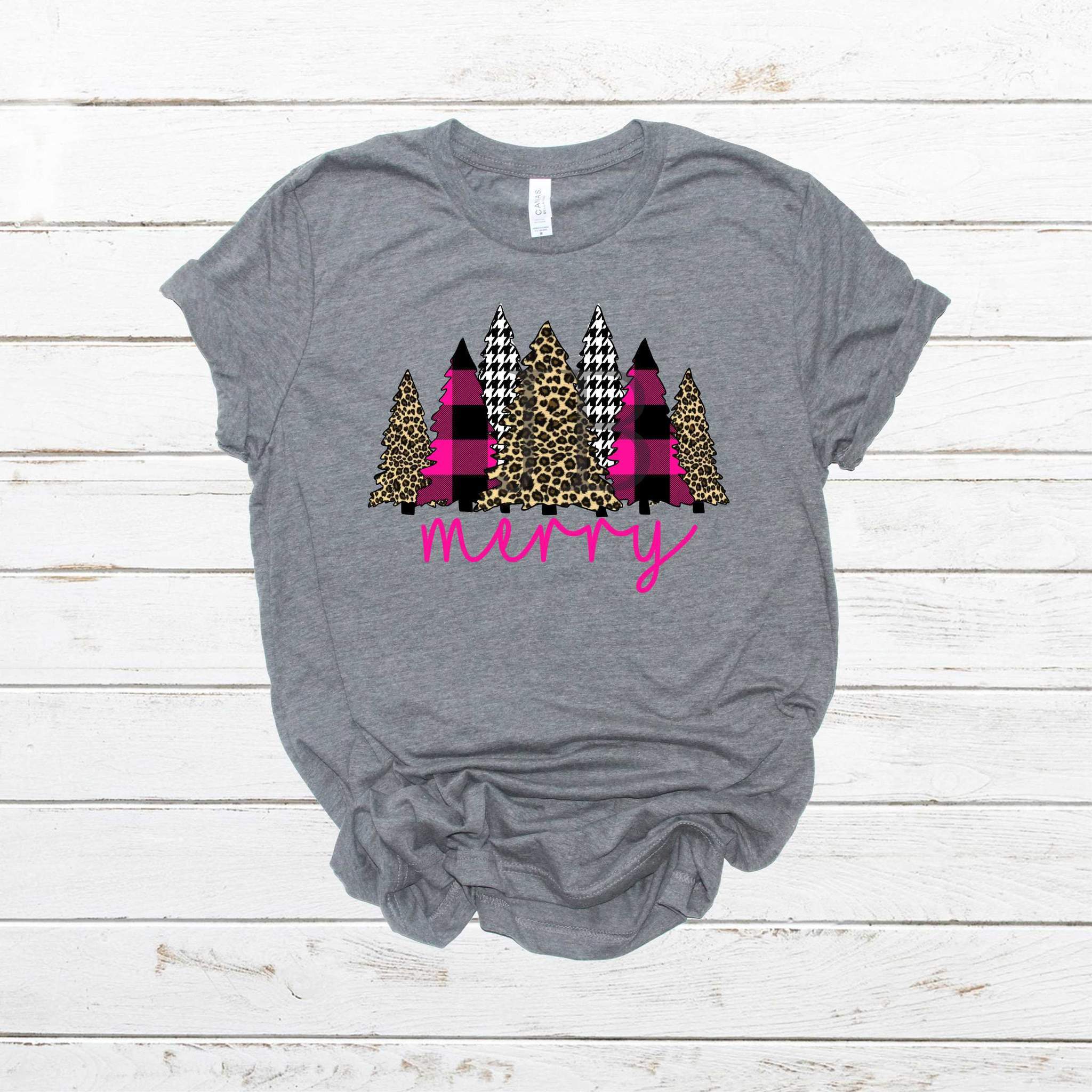 A stylish pink leopard print graphic tee featuring Christmas trees, perfect for holiday celebrations.