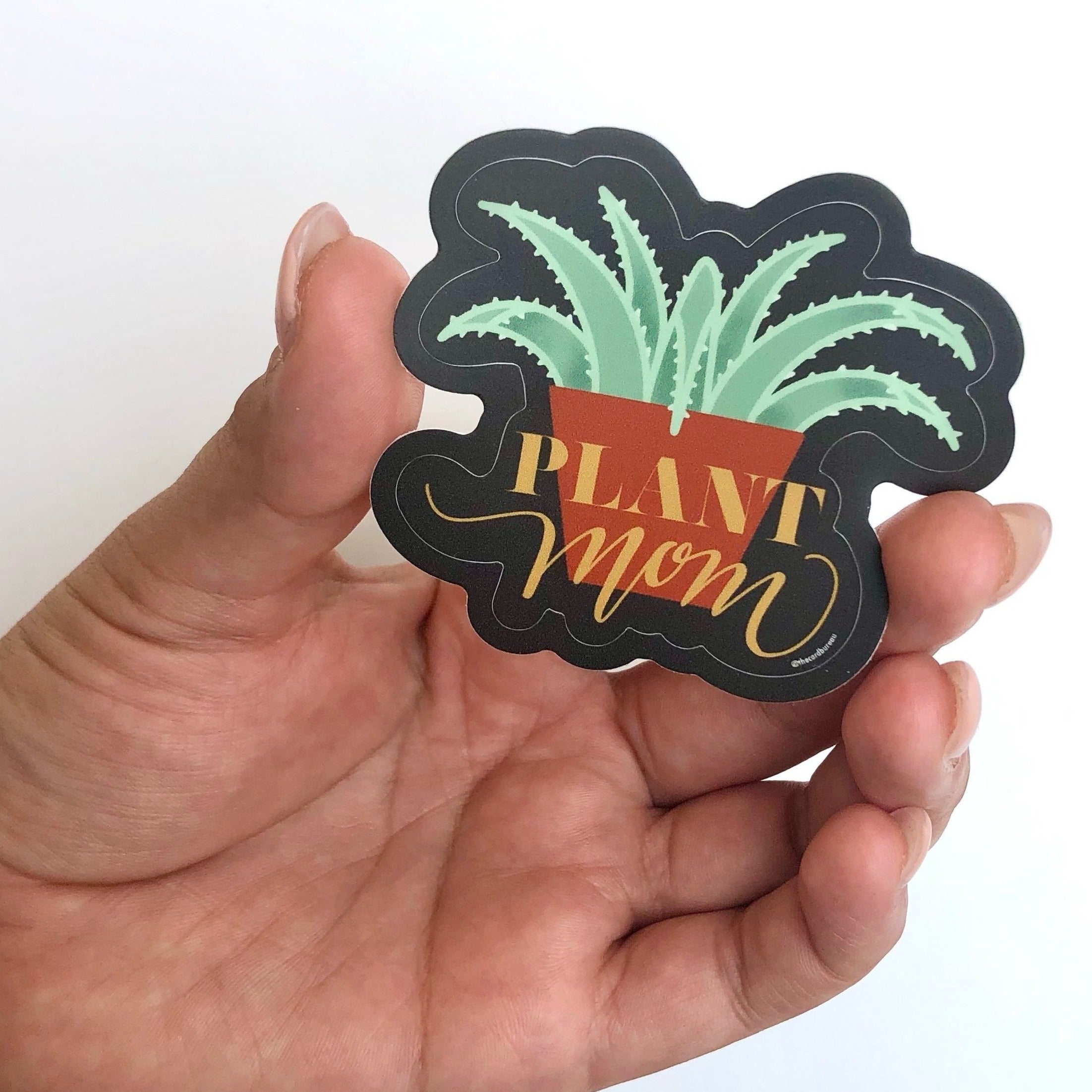 A cute vinyl sticker that reads 'Plant Mom', perfect for personalizing laptops and notebooks.