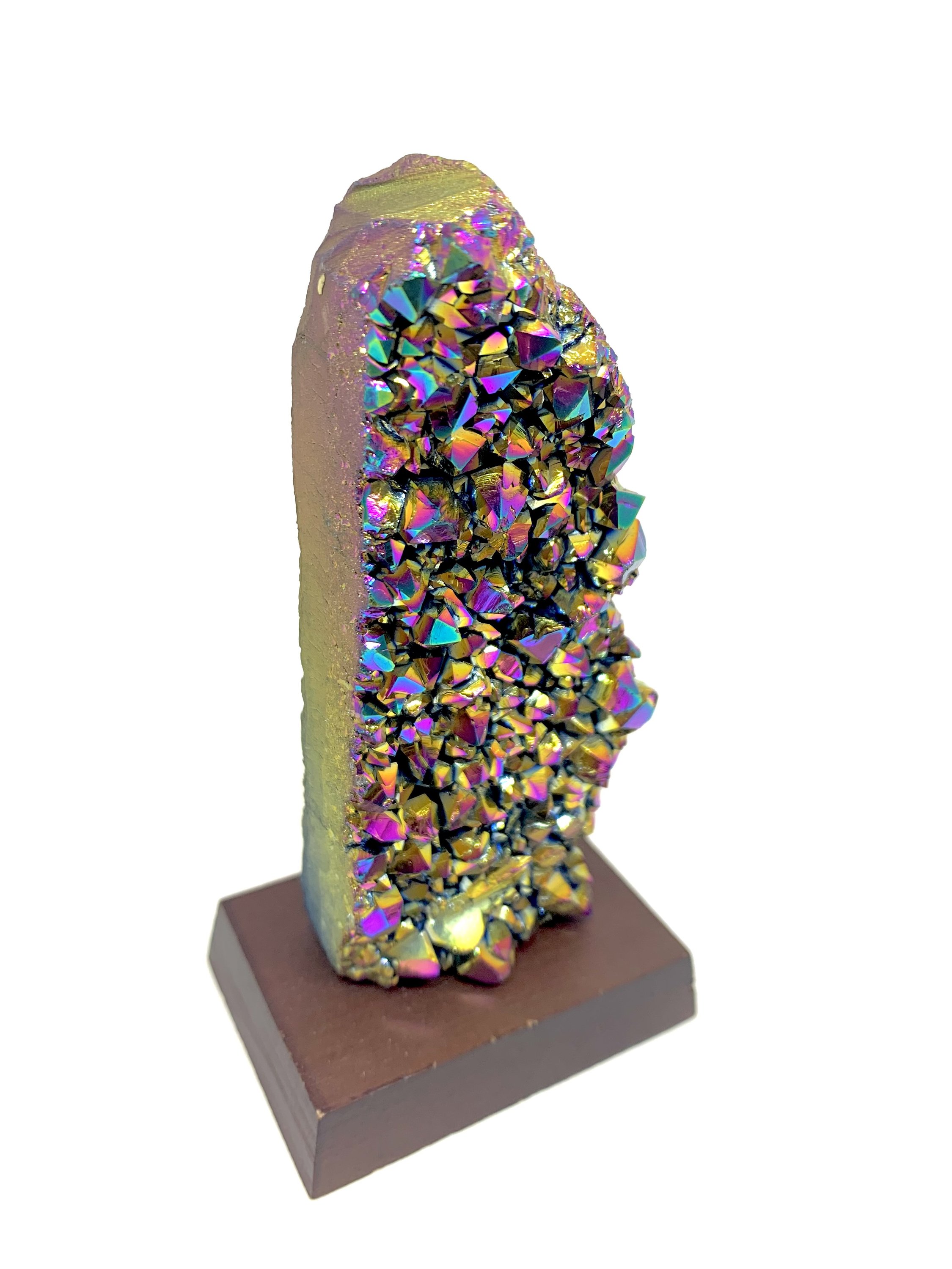 A vibrant Rainbow Amethyst Cluster showcasing shades of pink, blue, green, yellow, red, and orange, displayed on a small wooden stand.