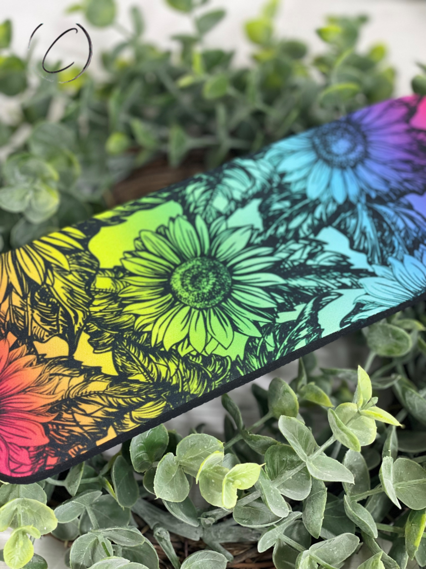 Colorful Rainbow Sunflowers Slap Wrap Can Cooler designed for 12oz cans and bottles, showcasing vibrant sunflower patterns.