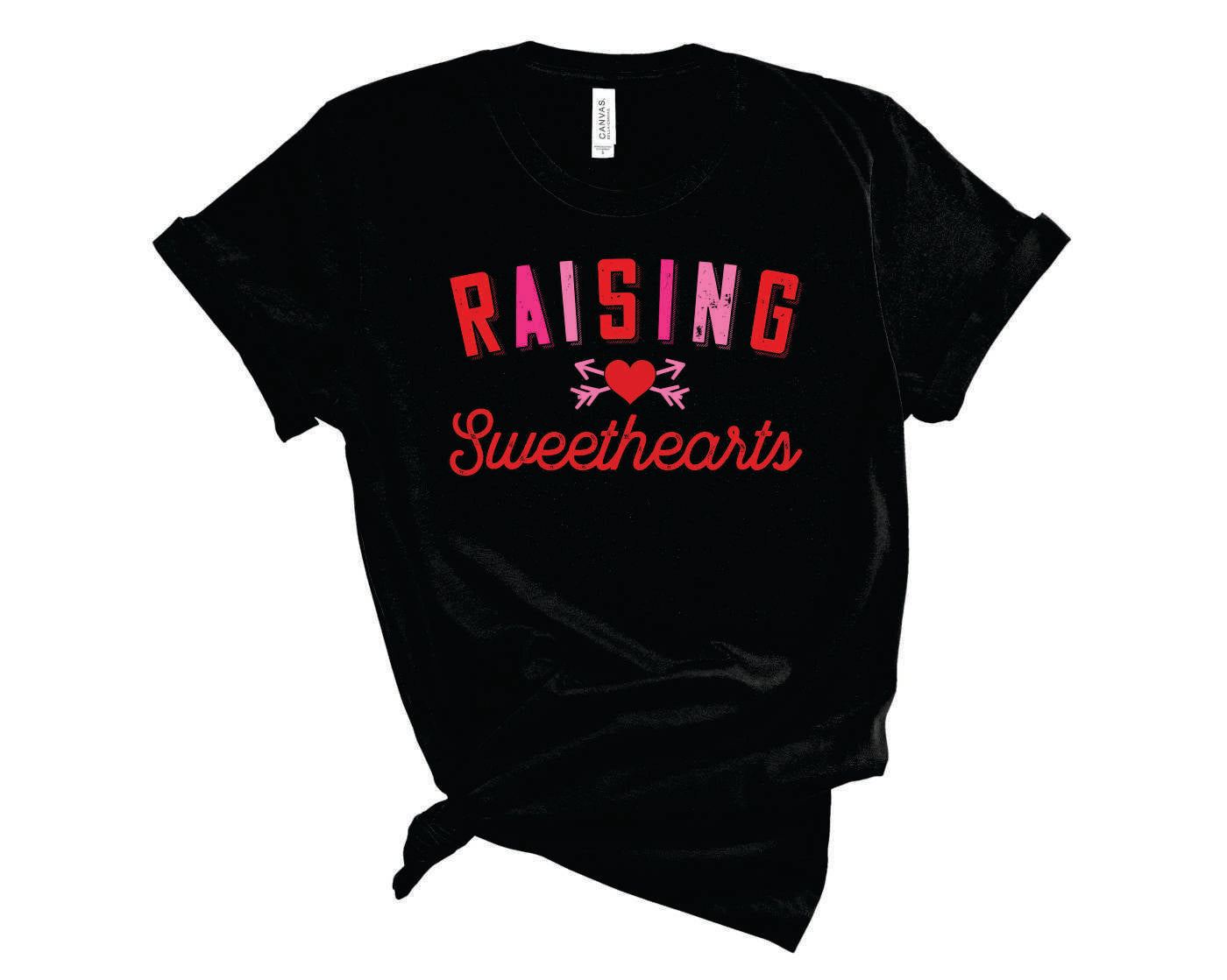 Raising Sweethearts Graphic Tee displayed on a hanger, featuring a vibrant graphic design on a soft fabric.