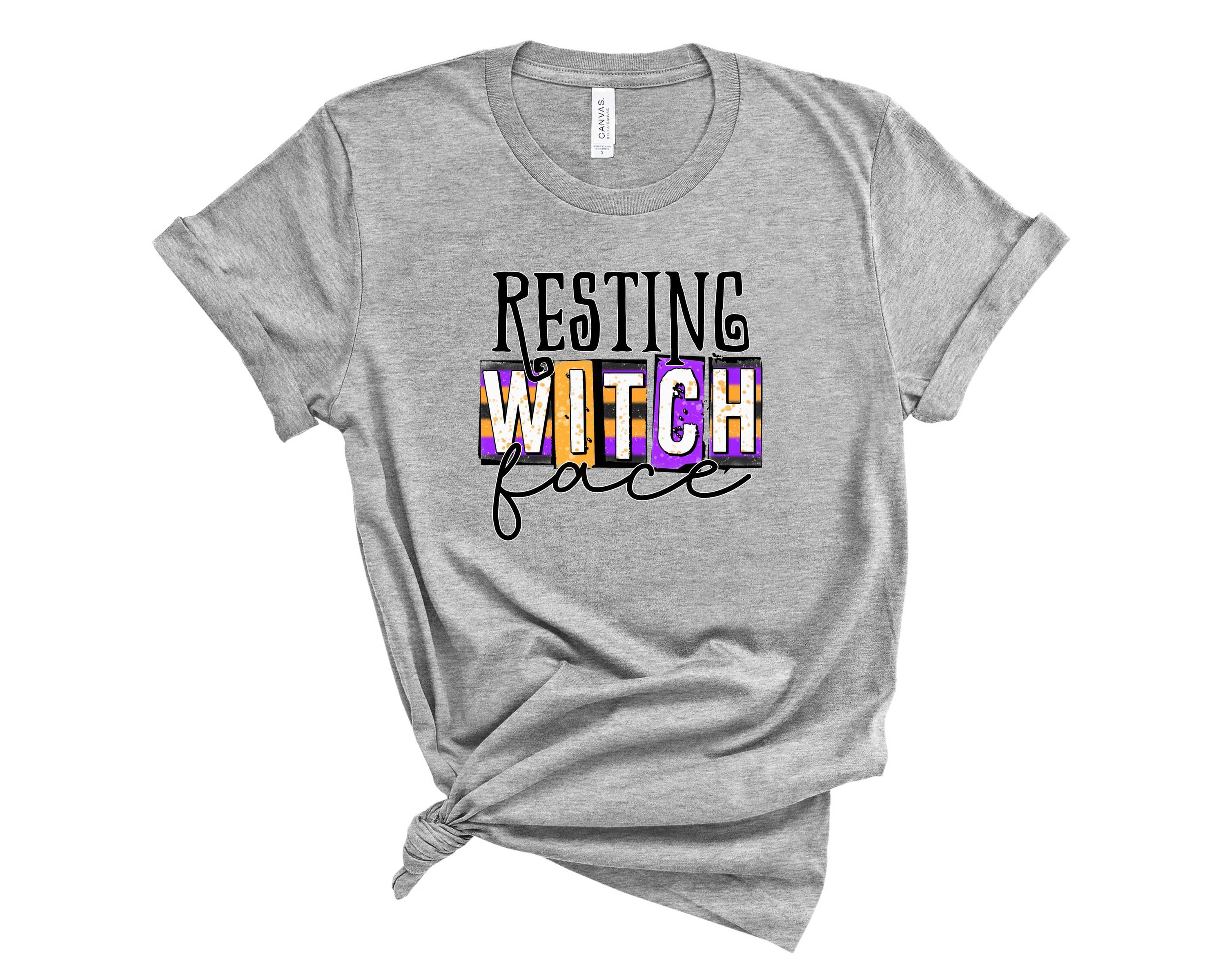 A black unisex t-shirt featuring the phrase 'Resting Witch Face' in bold white lettering, perfect for Halloween.