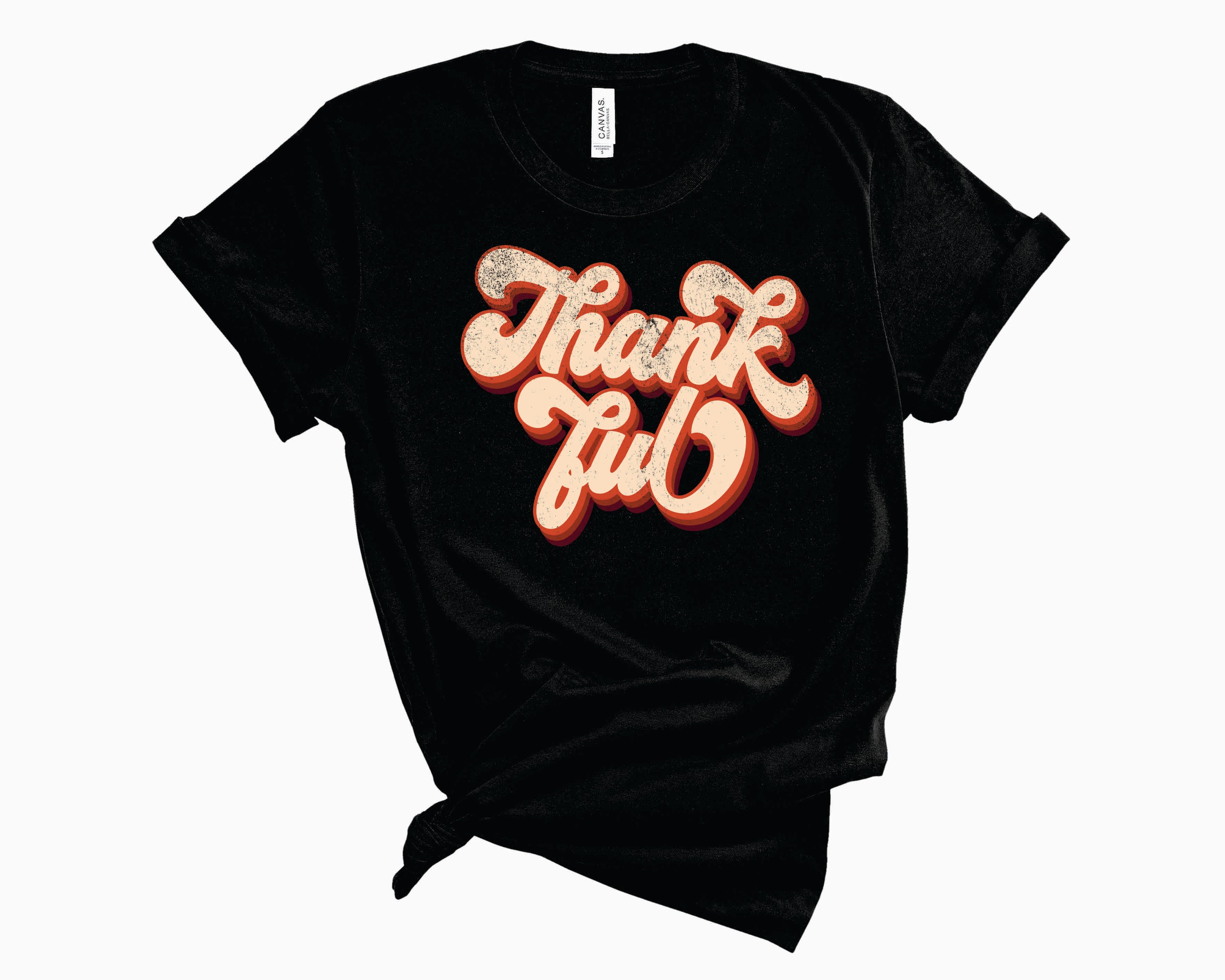 A unisex Retro Thankful Graphic Tee featuring a vintage-inspired design with a colorful gratitude message.