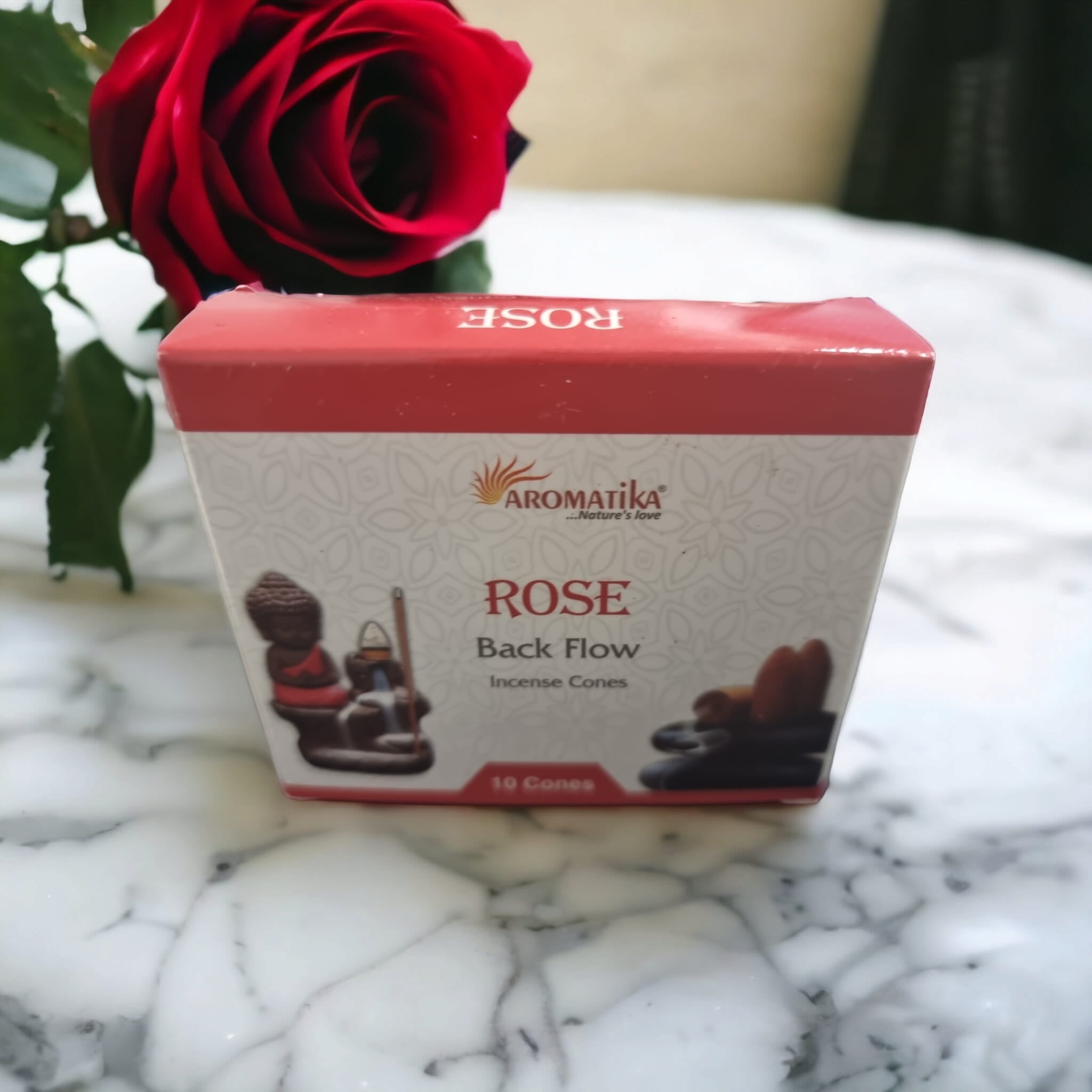 A pack of 10 Rose Backflow Incense Cones with a floral design, showcasing the cones and their unique downward smoke flow.