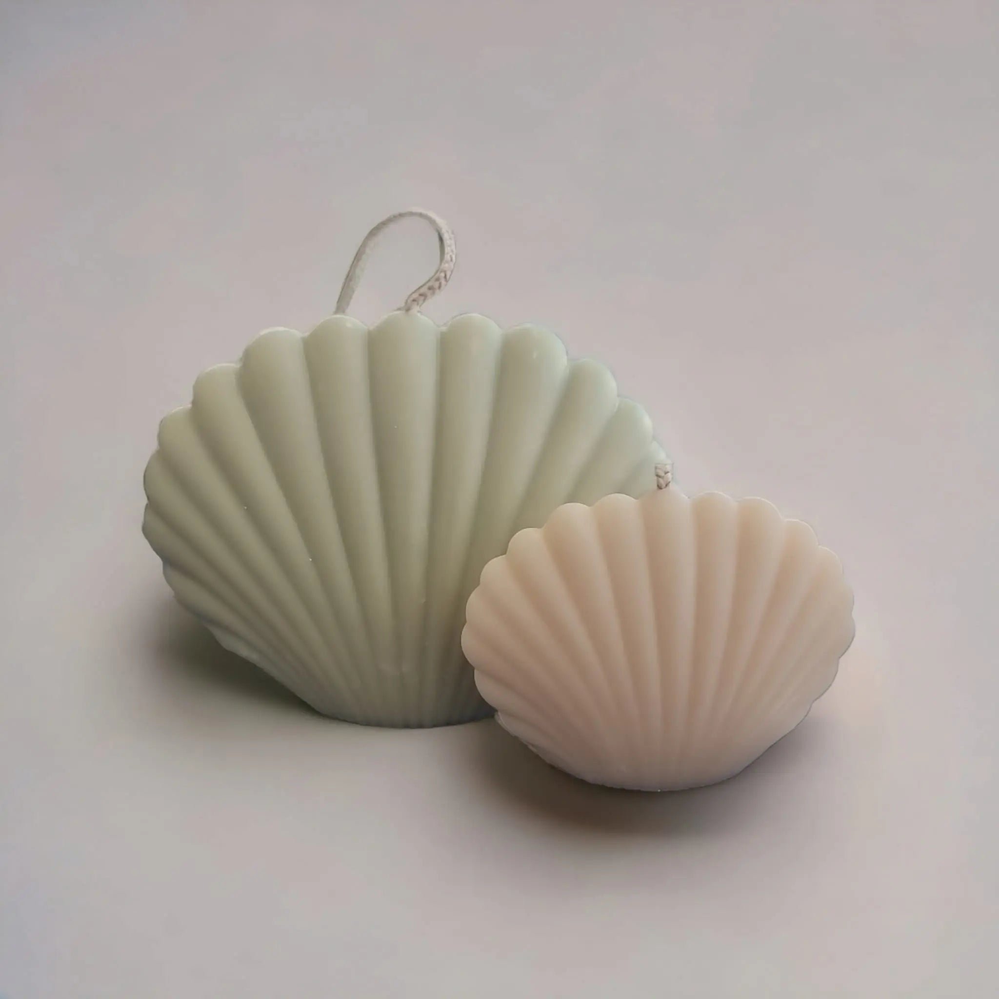 A set of two Rosemary & Bay Wreath Seashell Candles, elegantly designed in seashell containers, showcasing coastal charm and aromatic appeal.