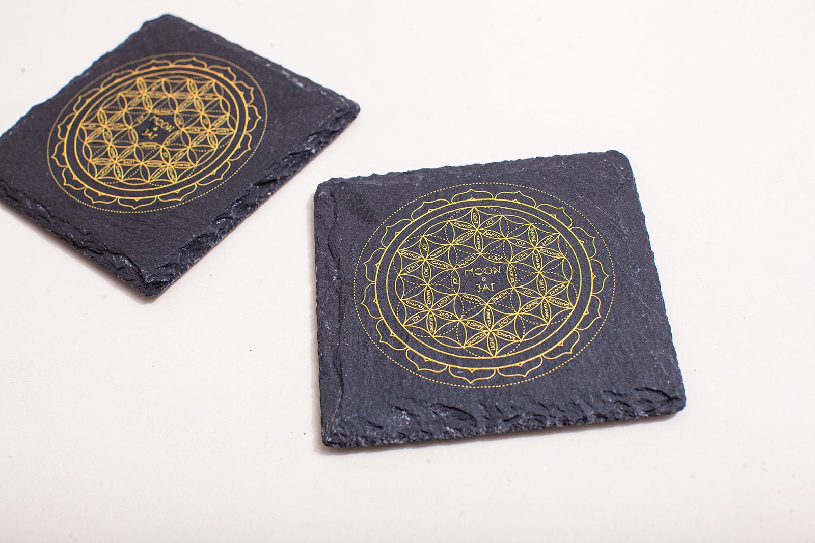 A beautifully designed slate charging plate featuring sacred geometry patterns, ideal for structuring and charging water.