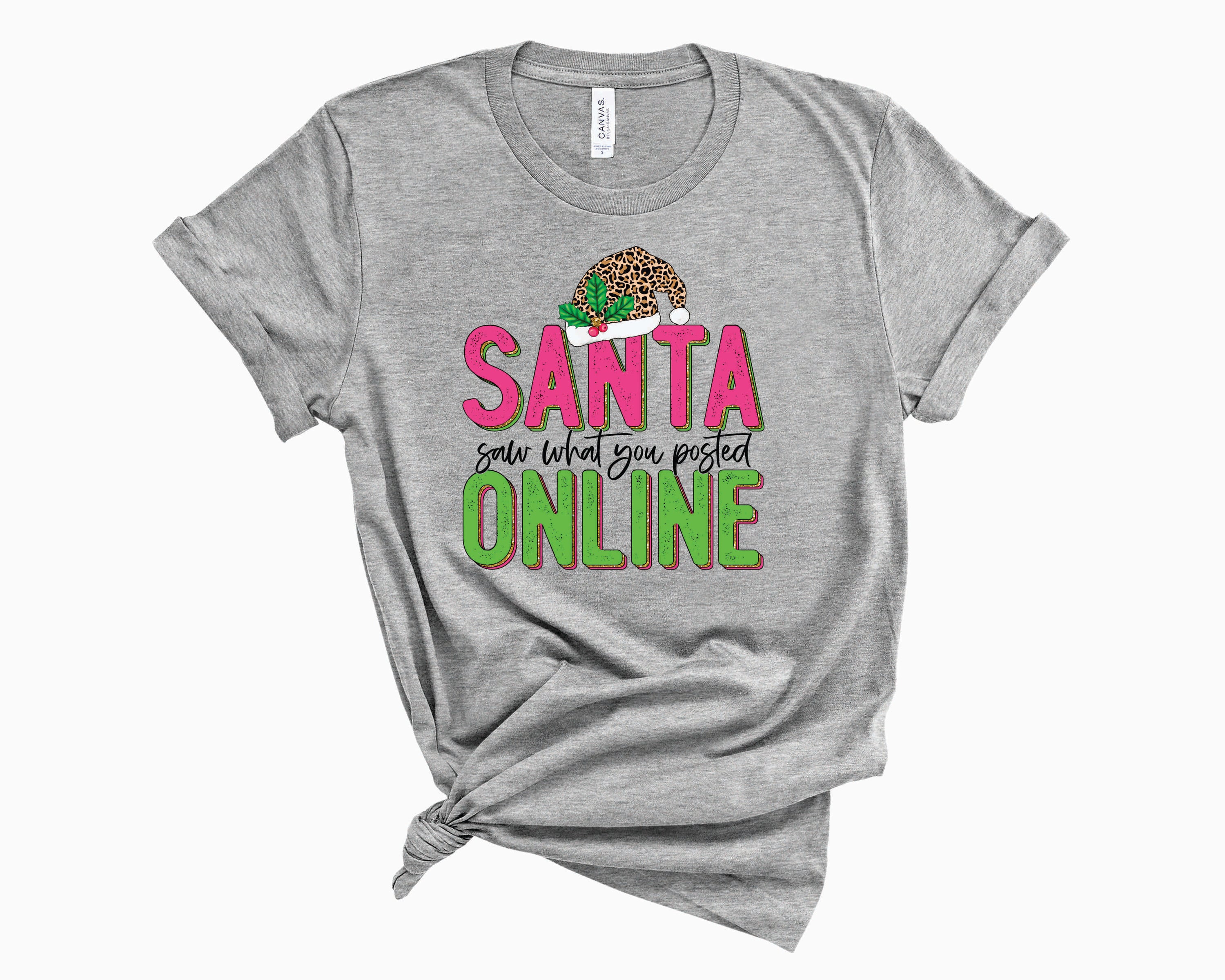 Santa Saw What You Posted Pink Leopard Graphic Tee featuring a playful design with pink leopard print and humorous text.